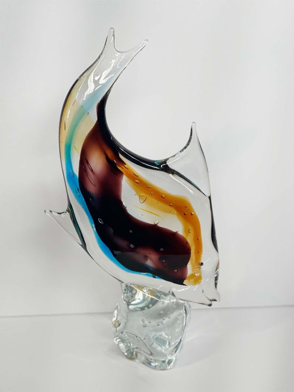 Murano fish sculpture by Sergio Costantini for Vetro Artistico Murano with dark purple,amber, green, blue and clear tone Murano glass. Made in Italy, 20th century.
Dimensions:
17.5