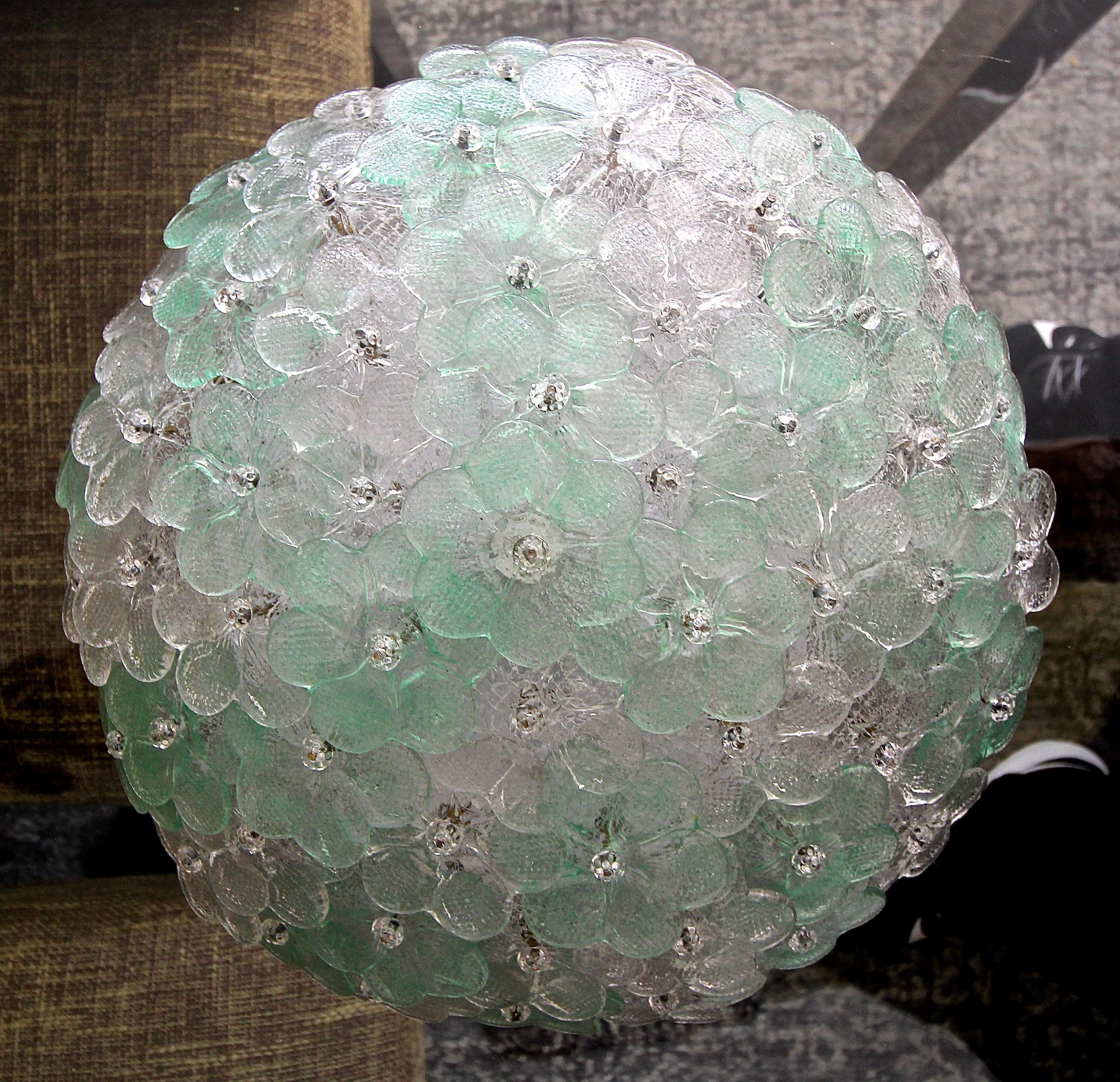Murano floral motif ceiling flush mount ceiling light. Composed of hand blown glass flowers with alternating clear and green accents. Affixed to a white metal 3-light ceiling frame. Uses 3 candelabra base bulbs. Newly wired.