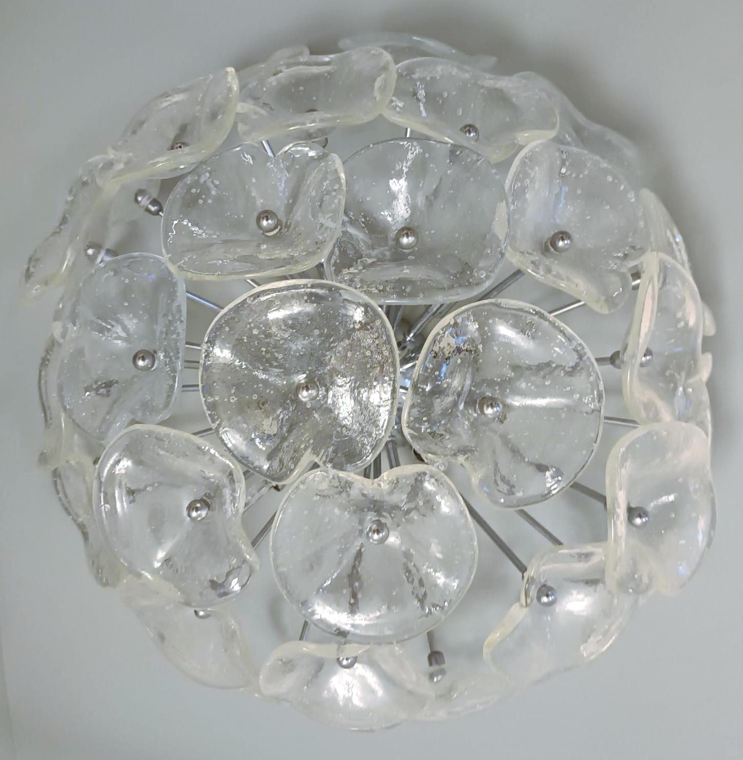 Vintage Italian flush mount with clear flower shaped Murano glasses mounted on chrome structure / Made in Italy circa 1960s
Measures: diameter 21.5 inches, height 12 inches
12 lights / G9 type / max 40W each
1 available in stock in Italy.
       