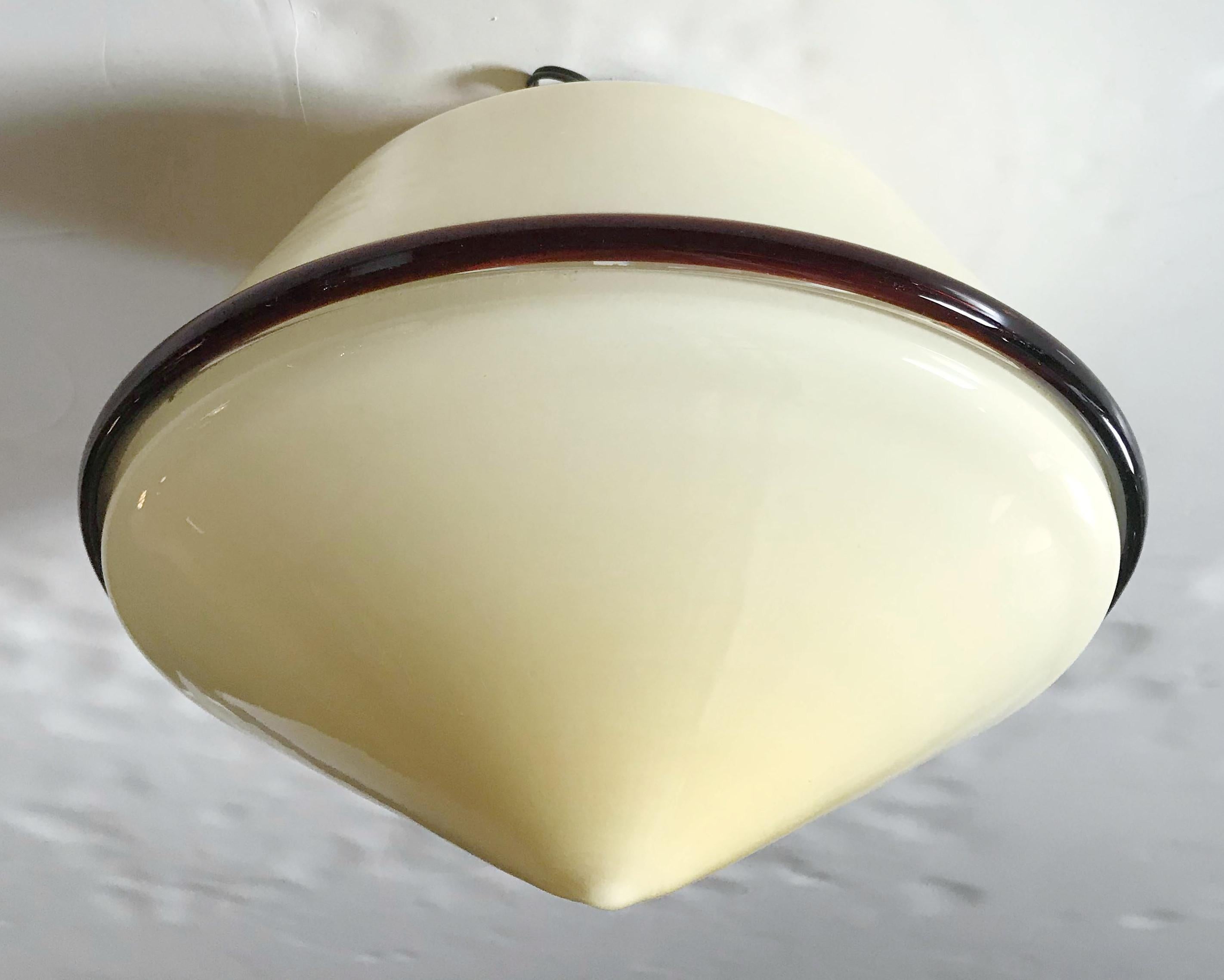 Vintage Italian cream colored Murano glass flush mount with a dark amber glass edge / Designed by De Majo Murano circa 1960's / Made in Italy / Original label on the glass
1 light / E26 or E27 type / max 60W
Diameter: 11 inches / Height: 8.5