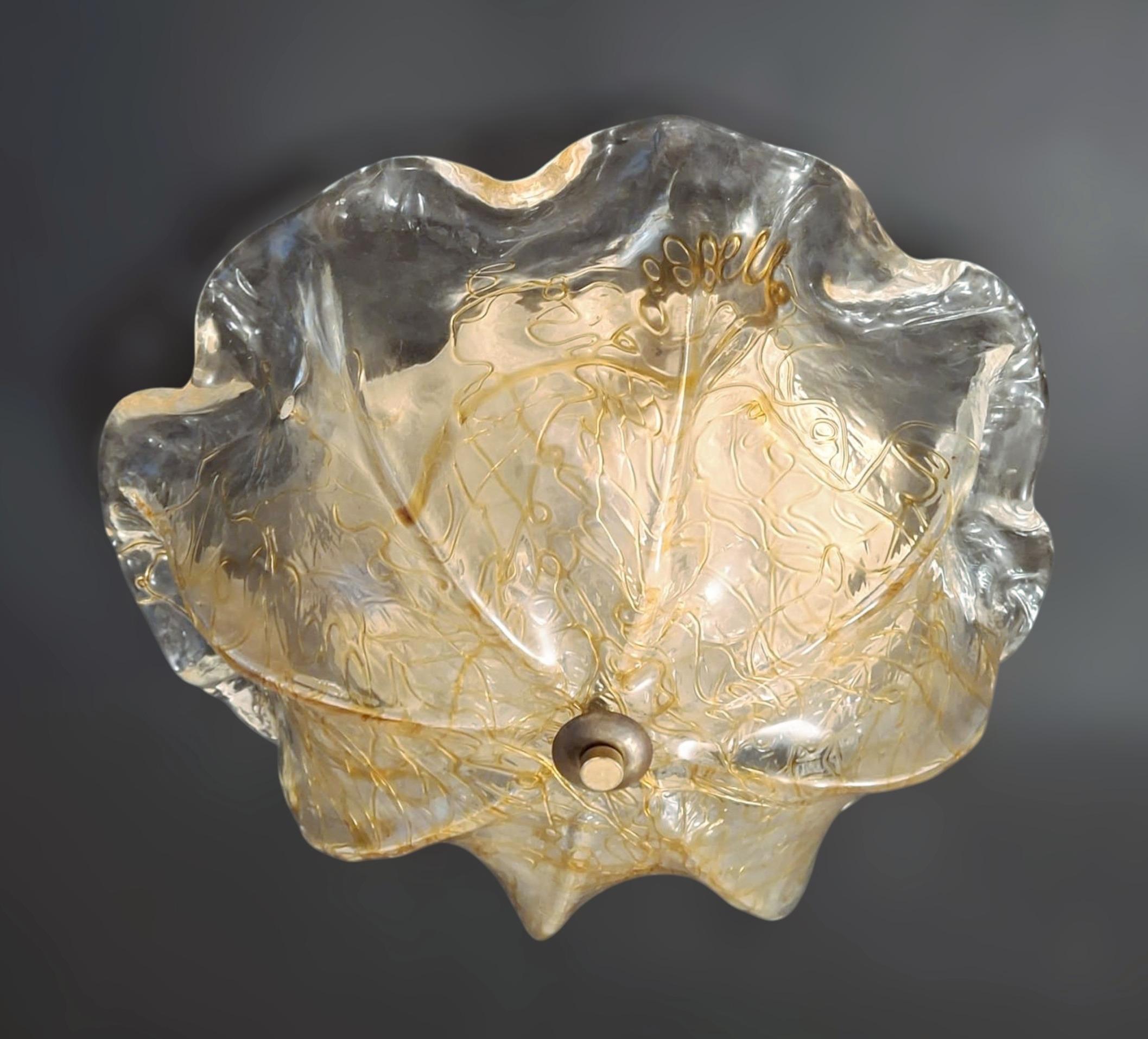 Vintage Italian flush mount with a single large clear textured Murano glass shade decorated with amber / Made in Italy by La Murrina, circa 1960s
Original stamp on the glass
Measures: diameter 16 inches, height 8.5 inches
3 lights / E12 or E14 type