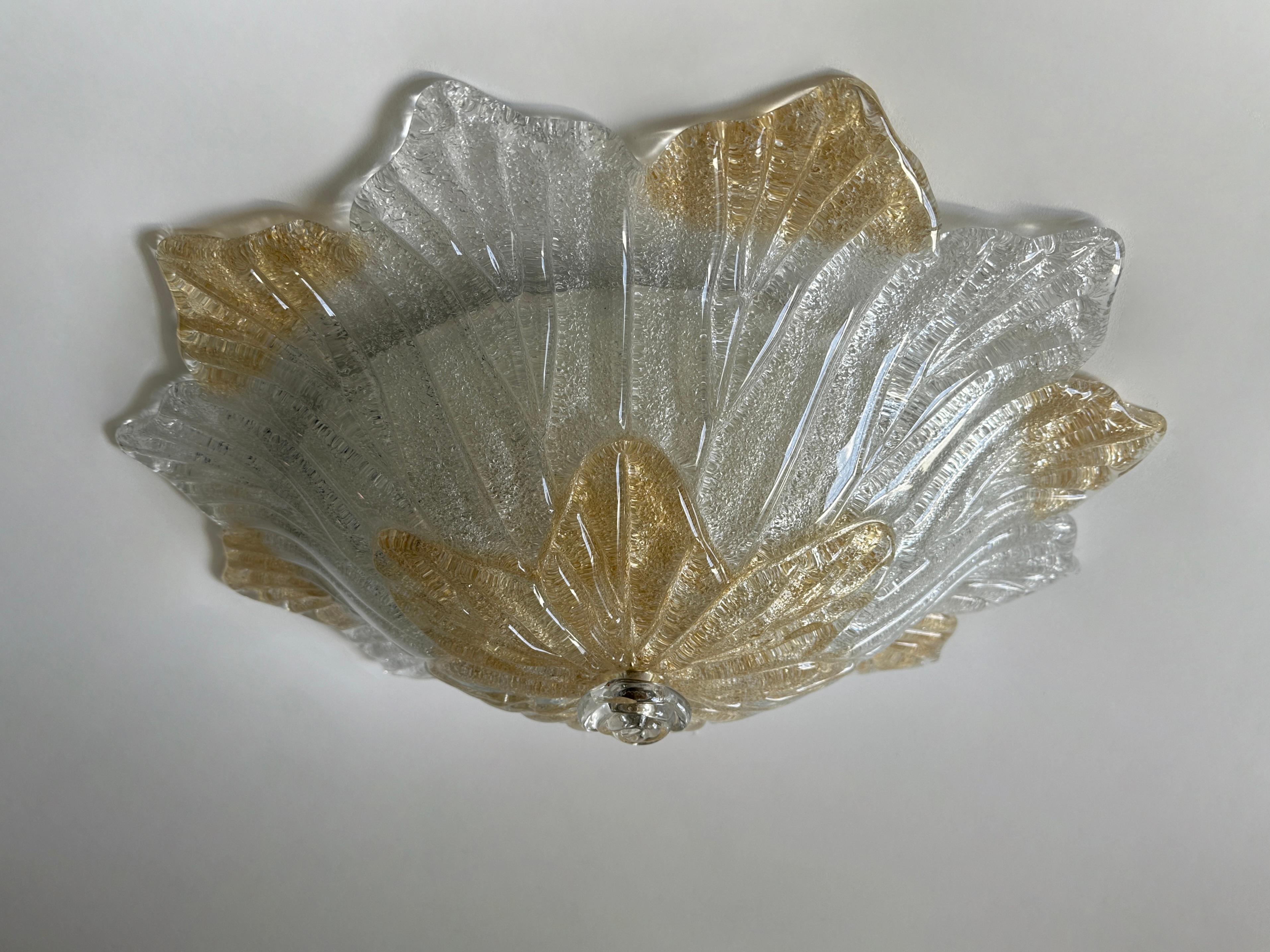 Murano glass flush mount ceiling light.
Designed and made in Italy in 1960s.
Hand blown Murano graniglia glass, enameled metal
Takes three candelabra bulbs. 
Complimentary US rewiring upon request.
Price is for 1 fixture.
2 fixtures are