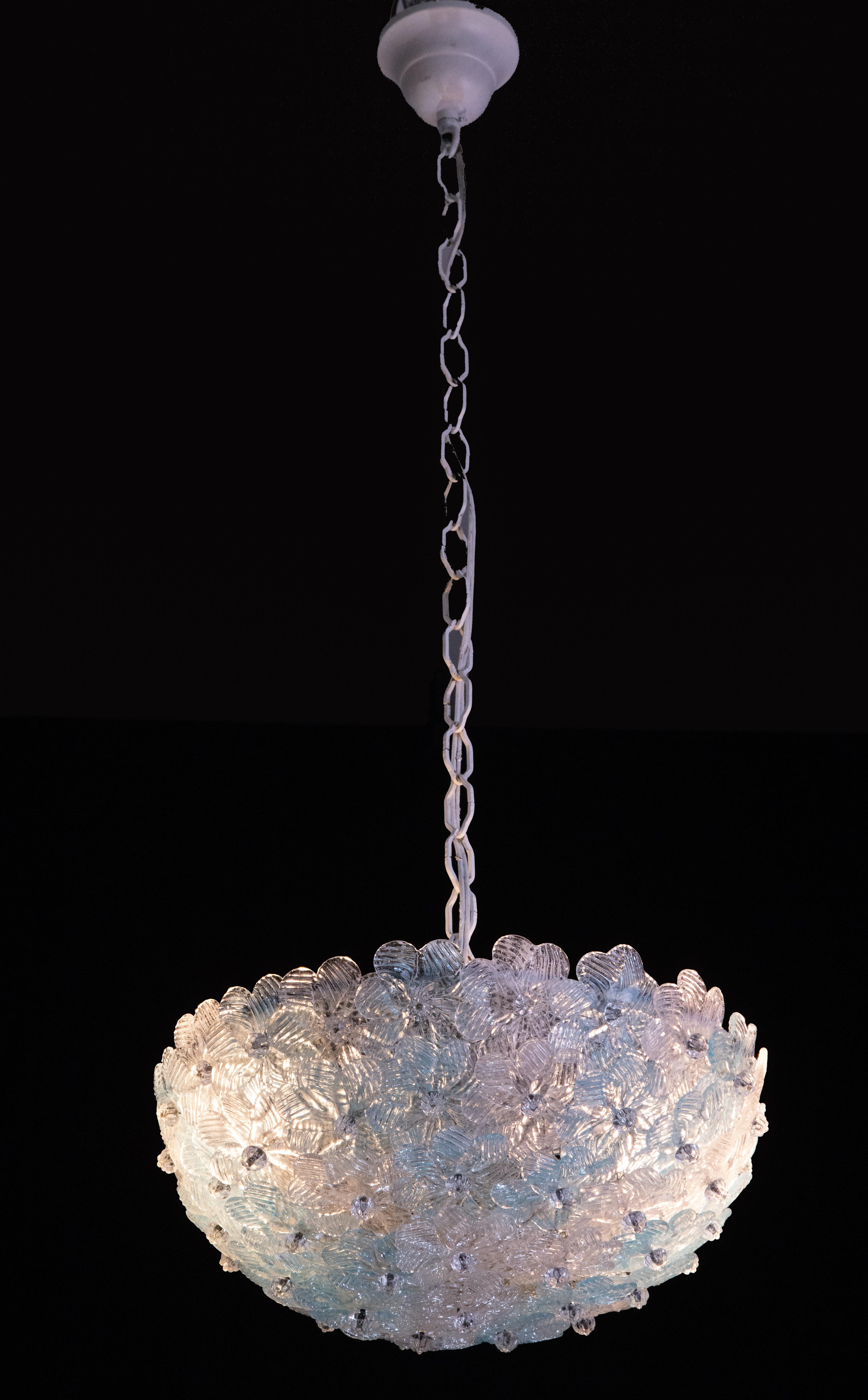 Pretty two-light ceiling lamp with Murano glass flowers, made by Seguso for Venin, Italy, 1960s.
White-painted metal ceiling basket with overlapping flowers made of hand-blown Murano glass in blue and transparent colors, attached individually.