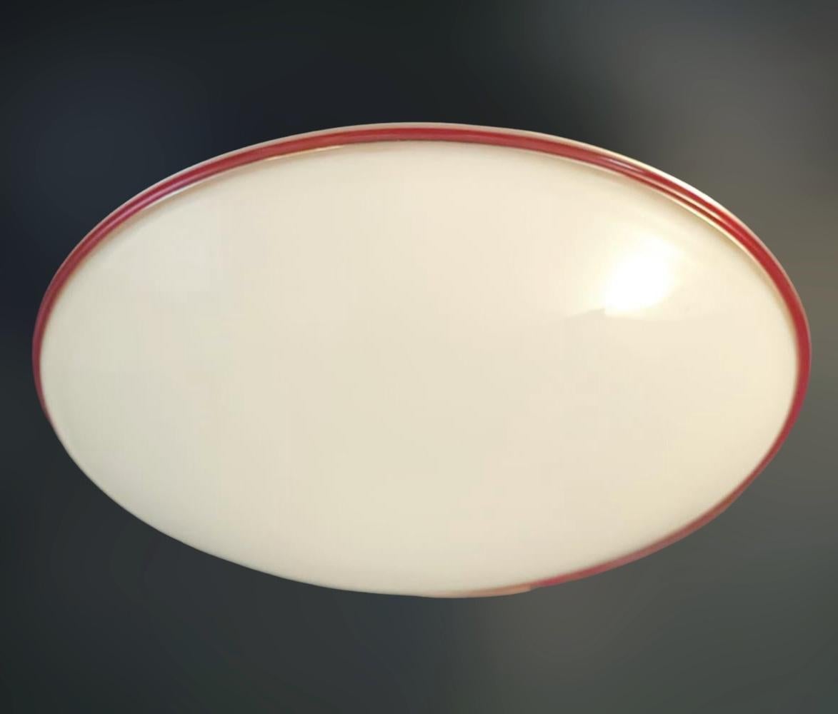 Vintage Italian flush mount or wall light with a single milky white Murano glass shade with red border / Made in Italy by Leucos, circa 1960s
Original mark on the frame
Measures: diameter 15 inches, height 5 inches
2 lights / E26 or E27 type / max