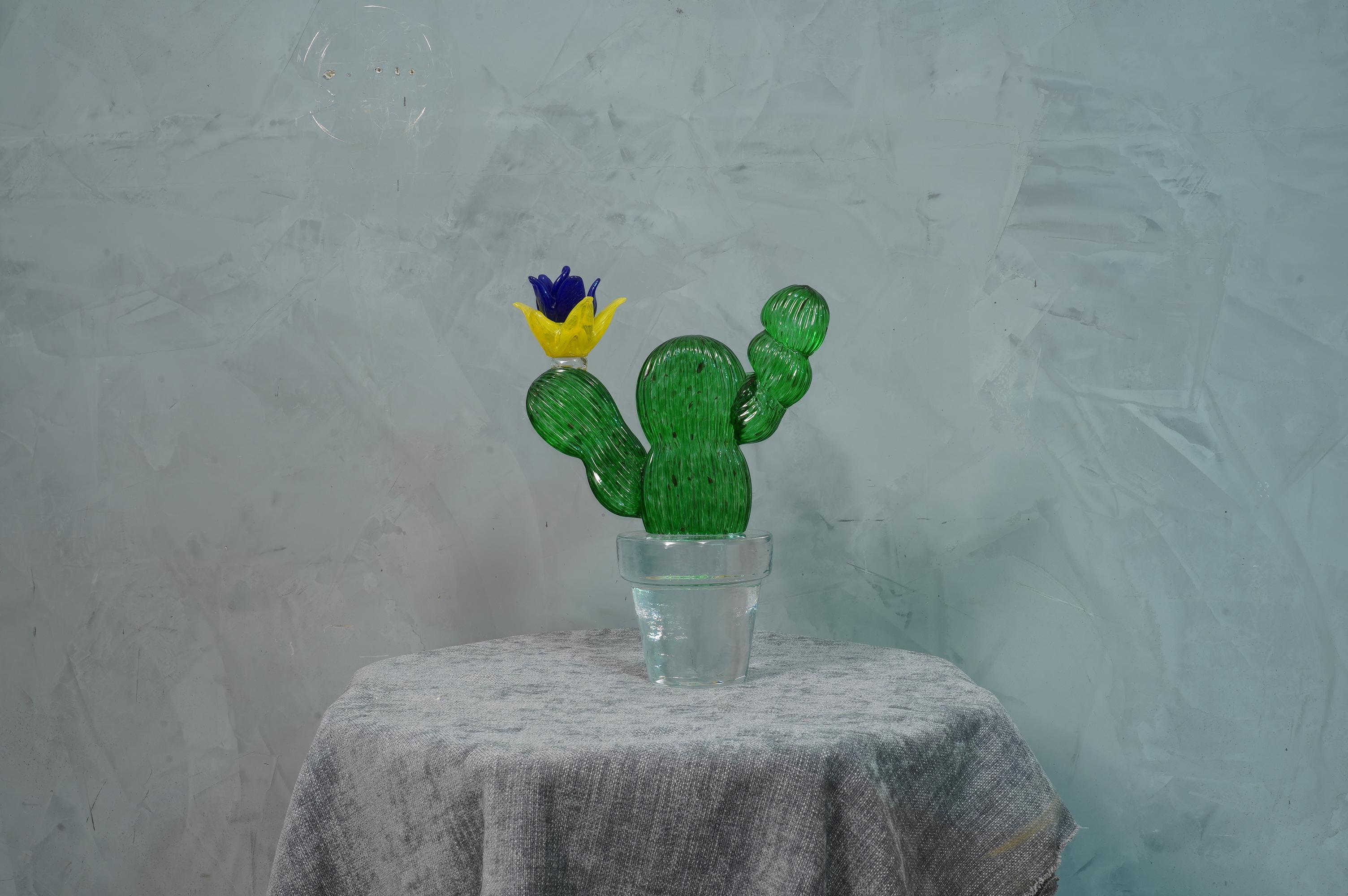 Italian design by Marta Marzotto creator of style, this cactus is a fashion icon of the Italian style, emerald green with a blue and yellow colored spot, the flower.

In limited edition, as can be seen from the writing under the transparent vase