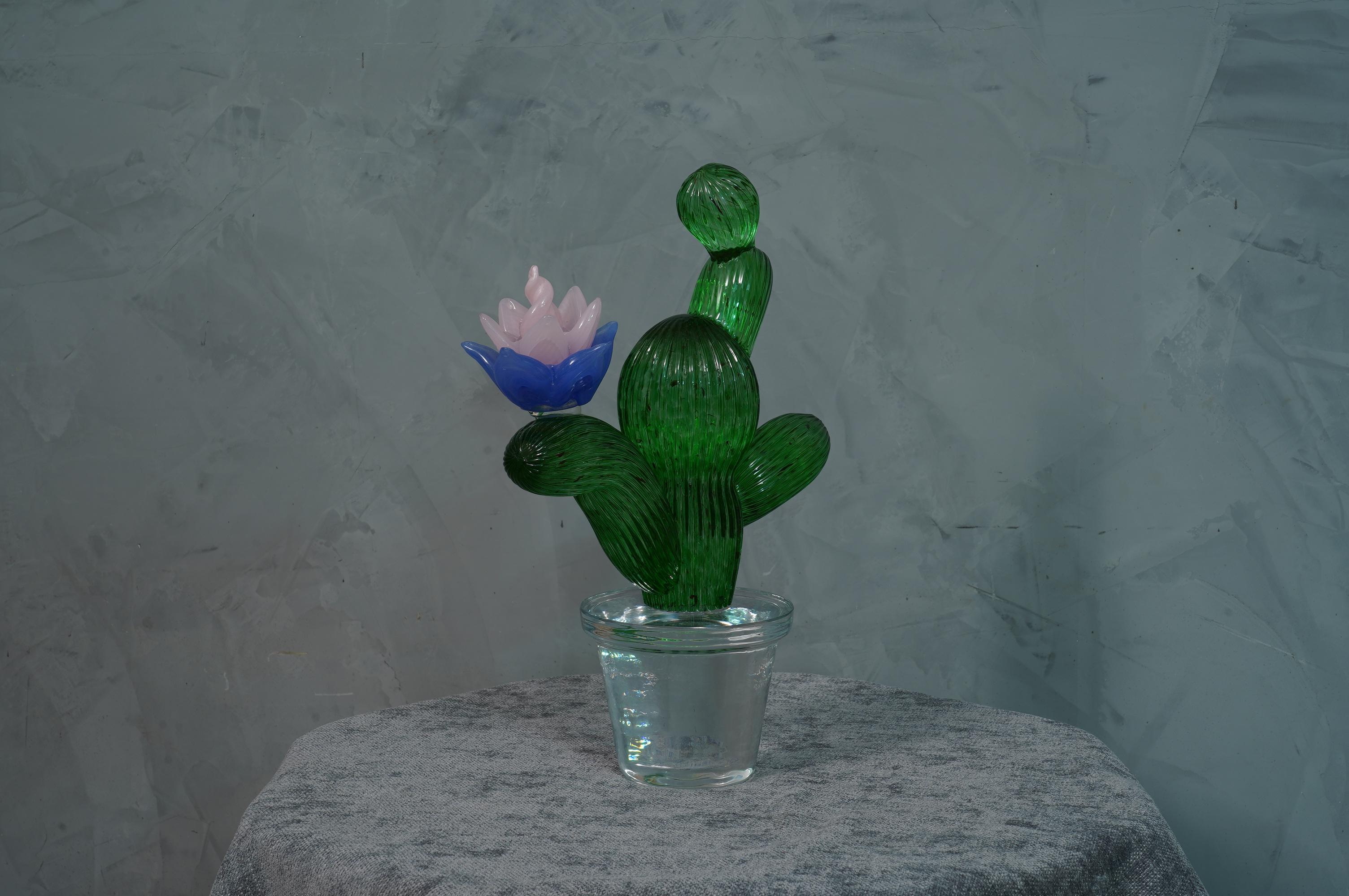 Italian design by Marta Marzotto creator of style, this cactus is a fashion icon of the Italian style, emerald green with a blue and yellow colored spot, the flower.

In limited edition, as can be seen from the writing under the transparent vase
