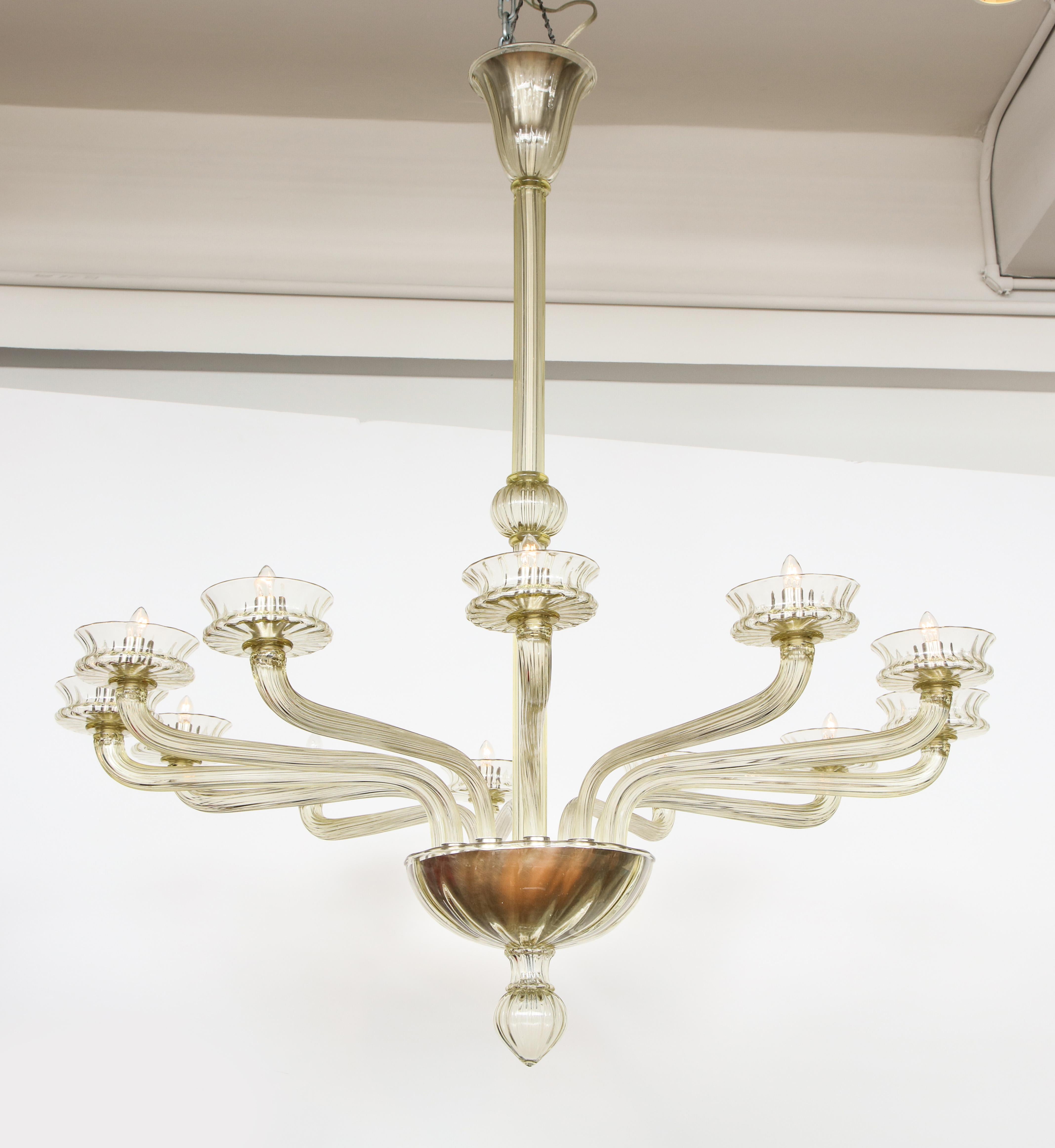 The whole hand blown, having a central stem supporting 12 arms, each with a fluted shade.
 