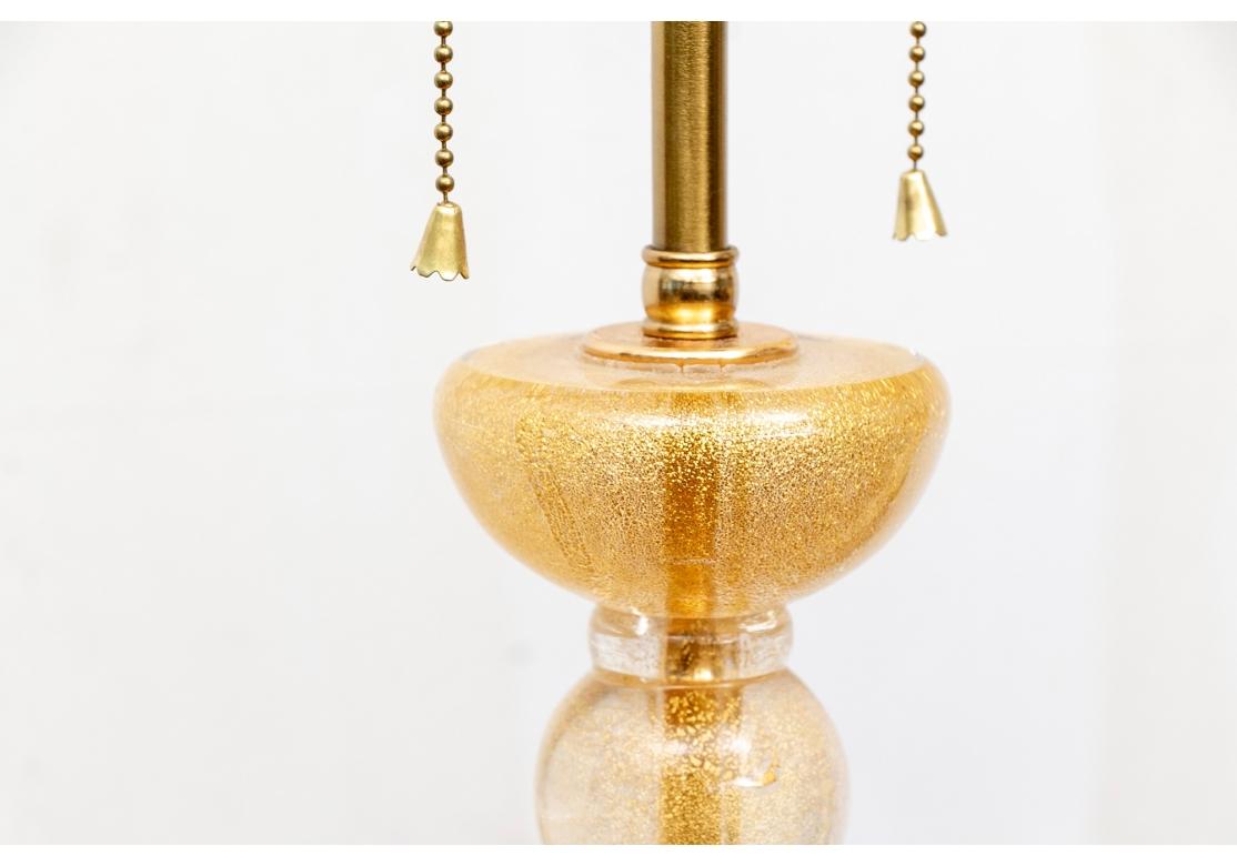 Classic Murano bubble lamps in their fine gilt glass with five graduated balls. Round domed bases. Twin lights with quality brass mounts and ball finials.

Dimensions: H. 29 1/2