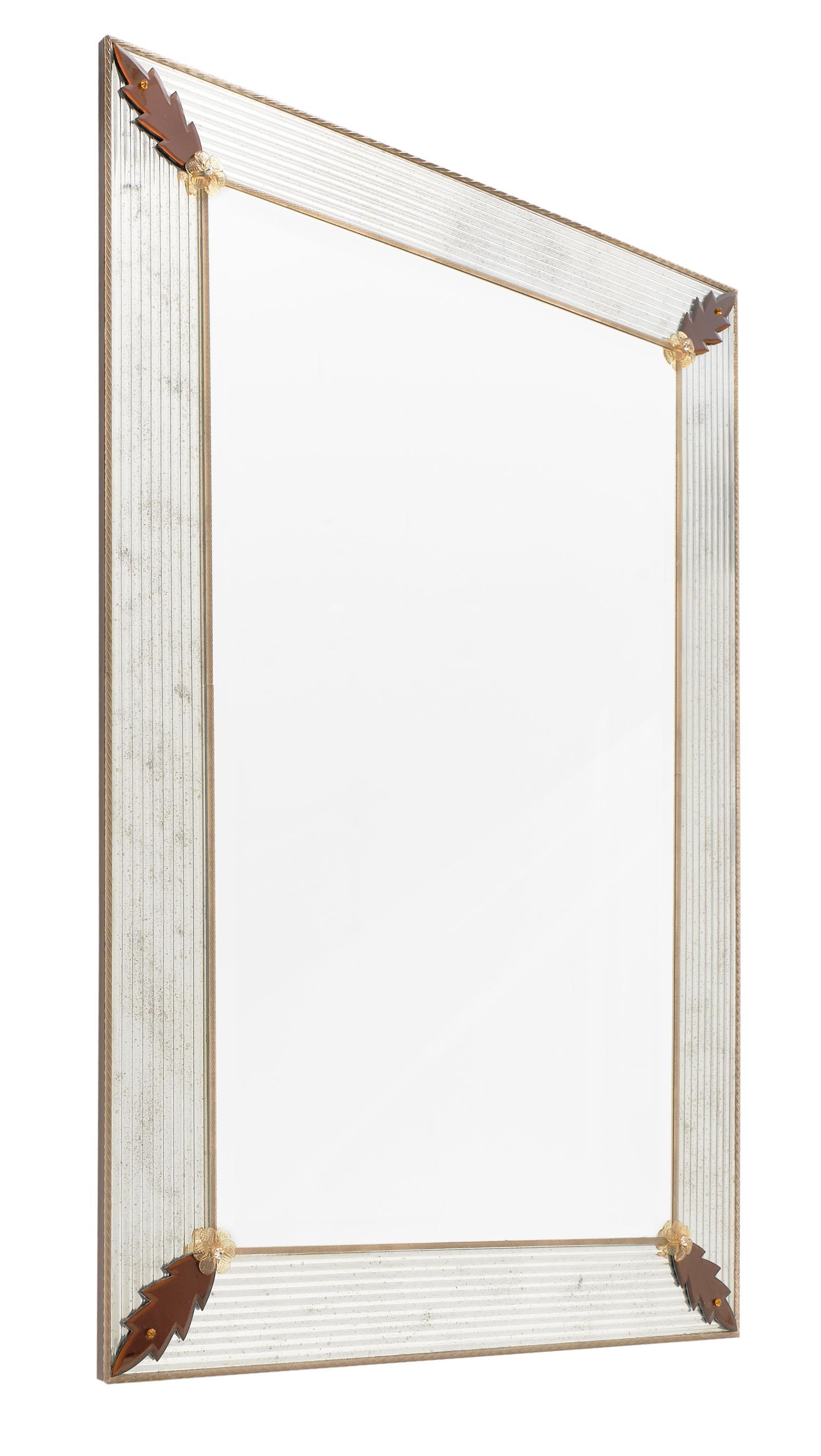 Murano glass amber leaf mirror by Giuliano Fuga. We love the beveled Murano glass which has been silvered and antiqued; framing the central mirror. The corners are adorned with amber leaf and flower details. It is a striking and impressive piece!