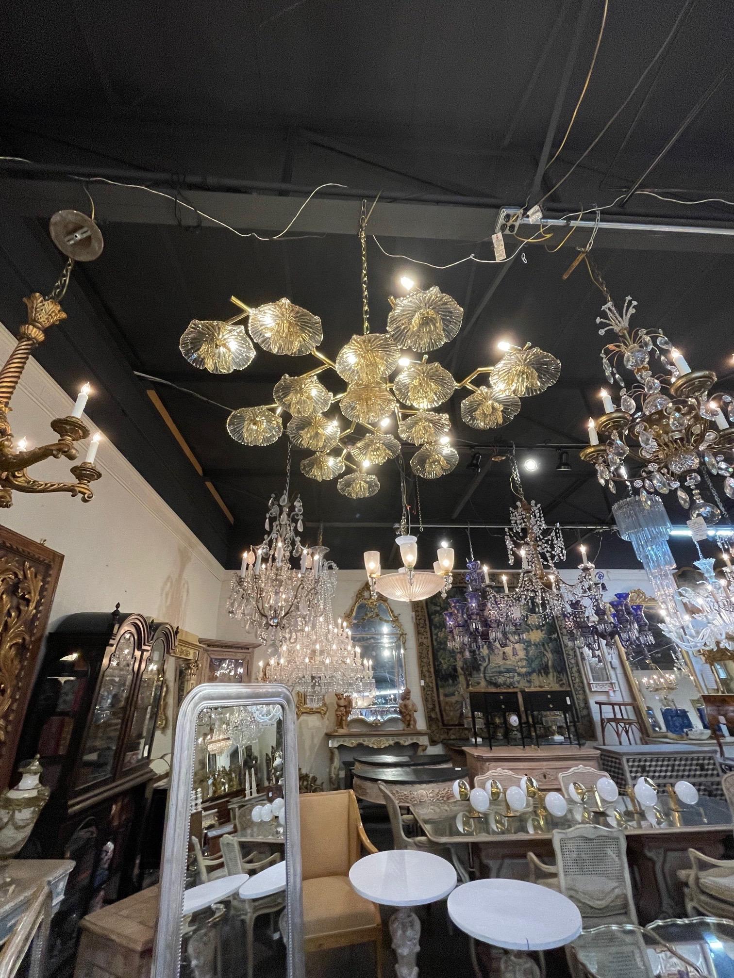 Exquisite Murano glass and brass flower form flush mount chandelier. Featuring beautiful glistening gold colored flowers on a brass base. Amazing! A true work of art.