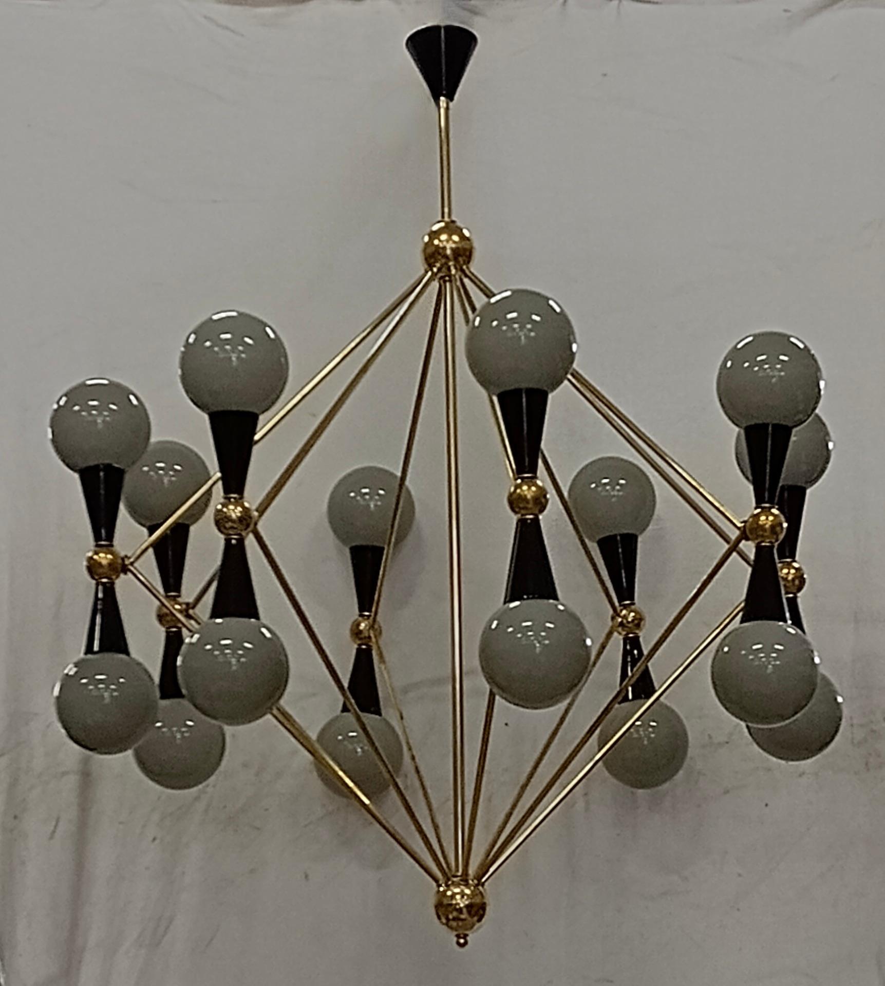 Particular circular sputnik, with brass structure and Murano grey glass spheres. It looks like a system of planets that gravitate circularly. A chandelier with a unique design of its kind, lots of brass and artistic green glass.

Chandelier with