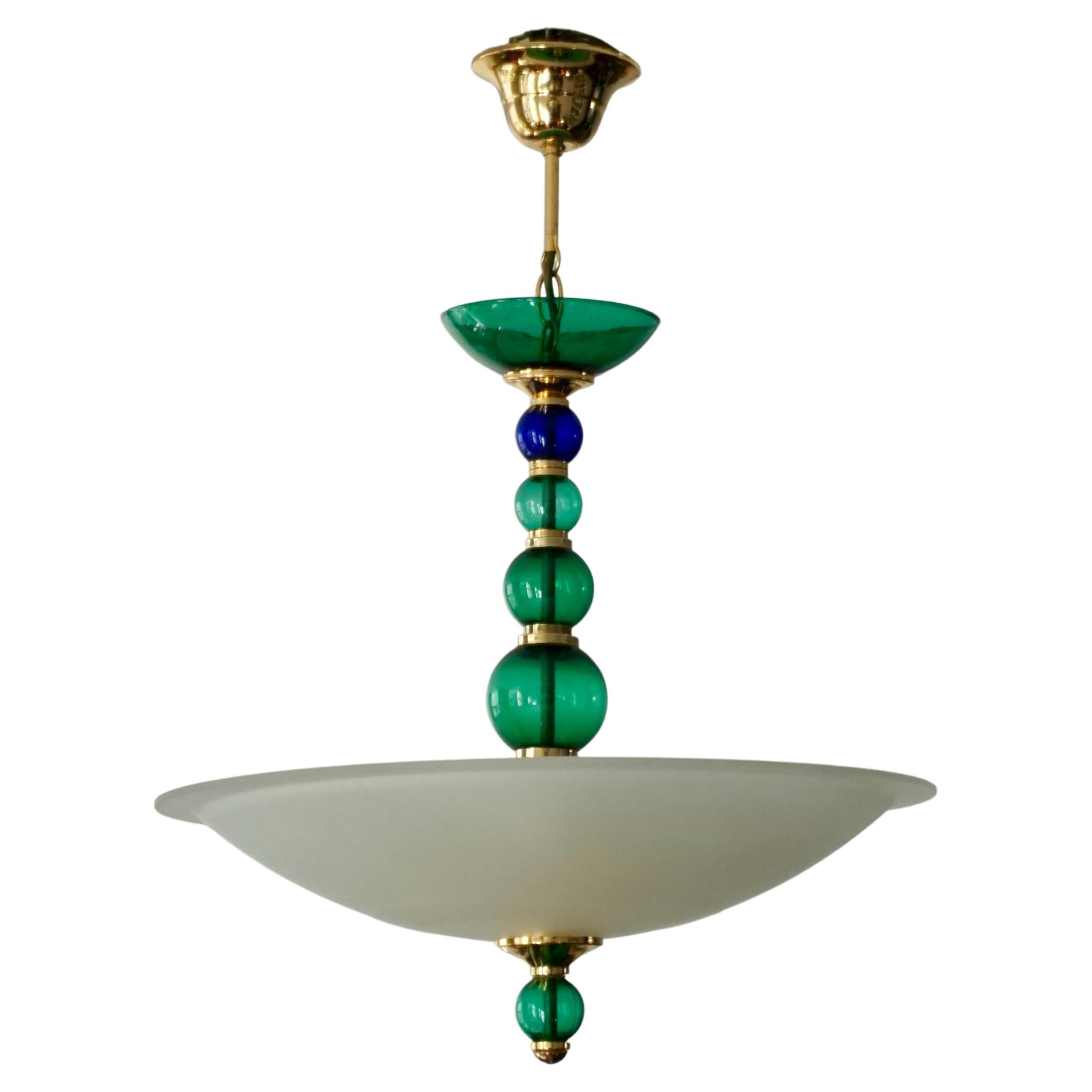 Murano glass pendant light by F Fabbian, Italy, 1970s. 

Large pair Italian ceiling lights in blue and green Murano glass.Consisting of a beautiful round shaped and wit colored glass bowl, mounted on and decorated with brass. Due the combination of