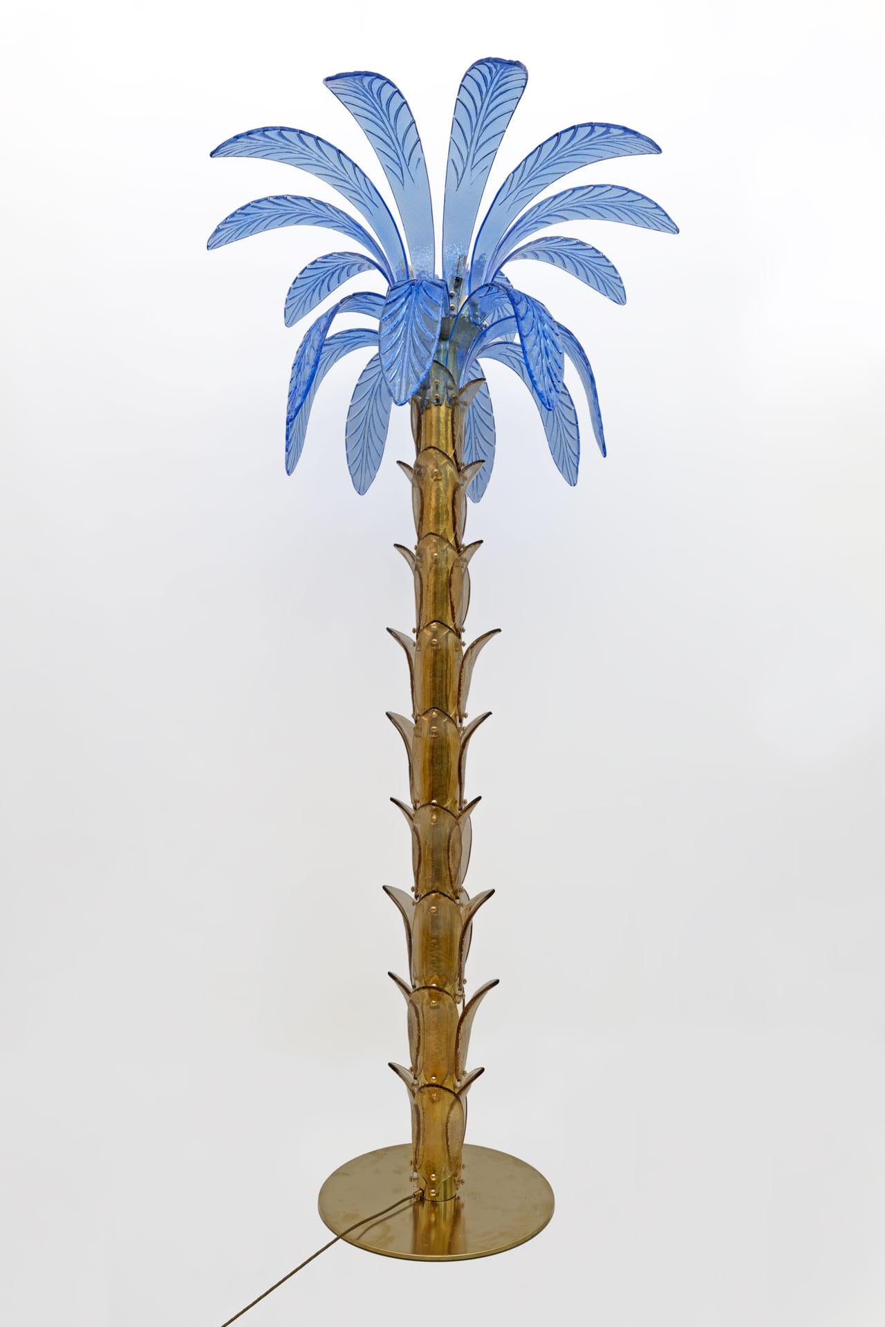 Floor lamp in amber and blue Murano blown glass, the structure is in brass, four bulbs. The floor lamp is also a sculpture that reproduces the trunk and leaves of a palm tree with pieces of glass.