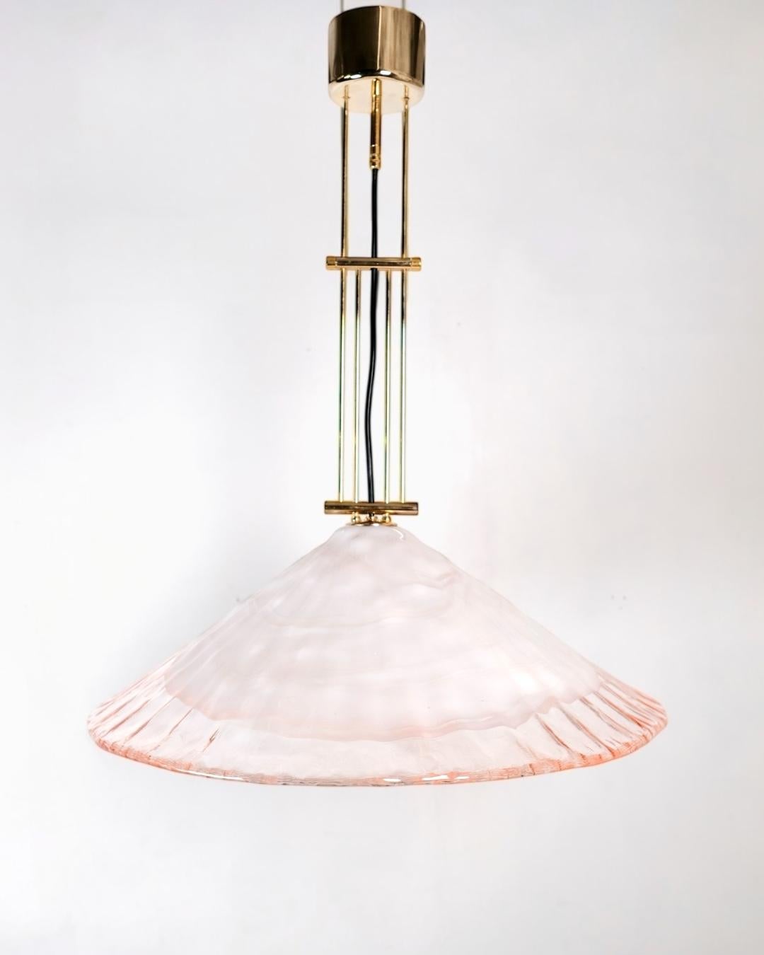 Murano glass and brass pendant light crafted by renowned Murano glassmaker La Murrina in Italy during the 1970s. 
It features a hand-blown Murano glass shade in a soft pink hue, topped with a beautifully diffused white “cloud-like” cap—an ethereal