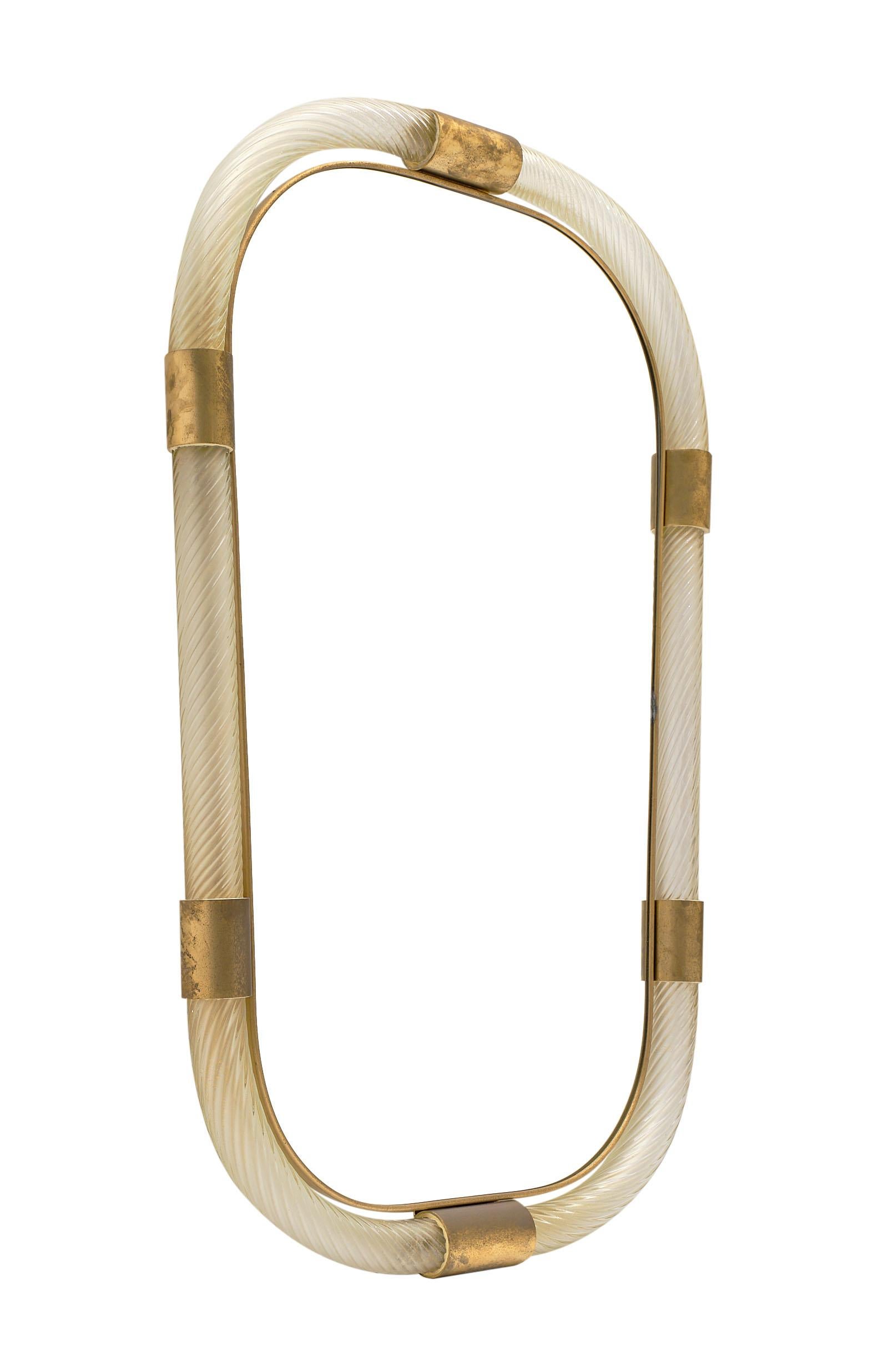Murano glass and brass “torsado” mirror by Giuliano Fuga. We love the brass framed oblong glass mirror surrounded by hand blown “torsado” glass with 23 carat gold fused within. A striking mirror!

This piece is currently located at our dealer's
