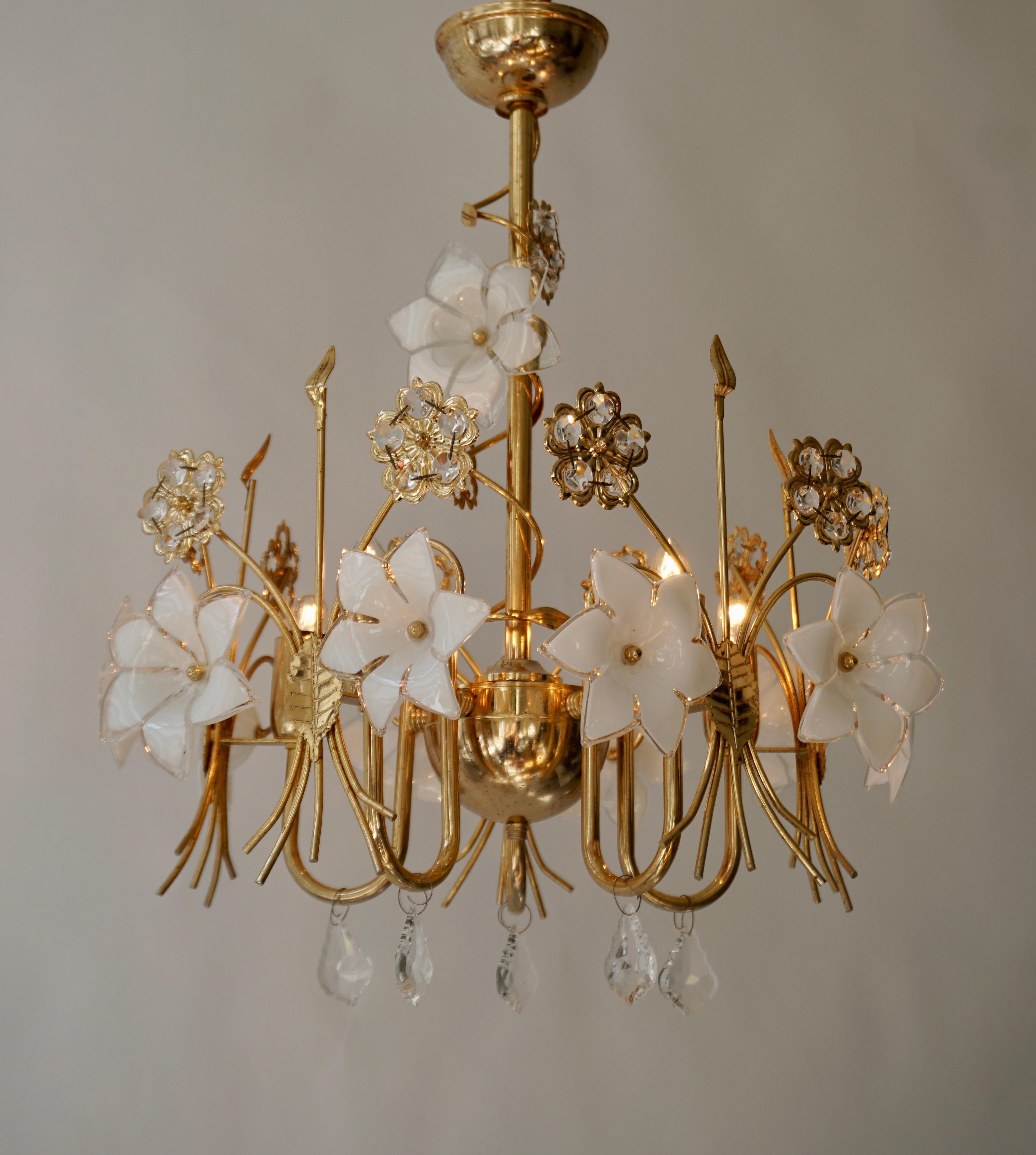 A Murano glass chandelier featuring  white glass flowers radiating from a brass frame with five standard sockets.

Charming ceiling light, composed of a golden base adorned with white Murano glass and crystal flowers. Every flower is unique in it's