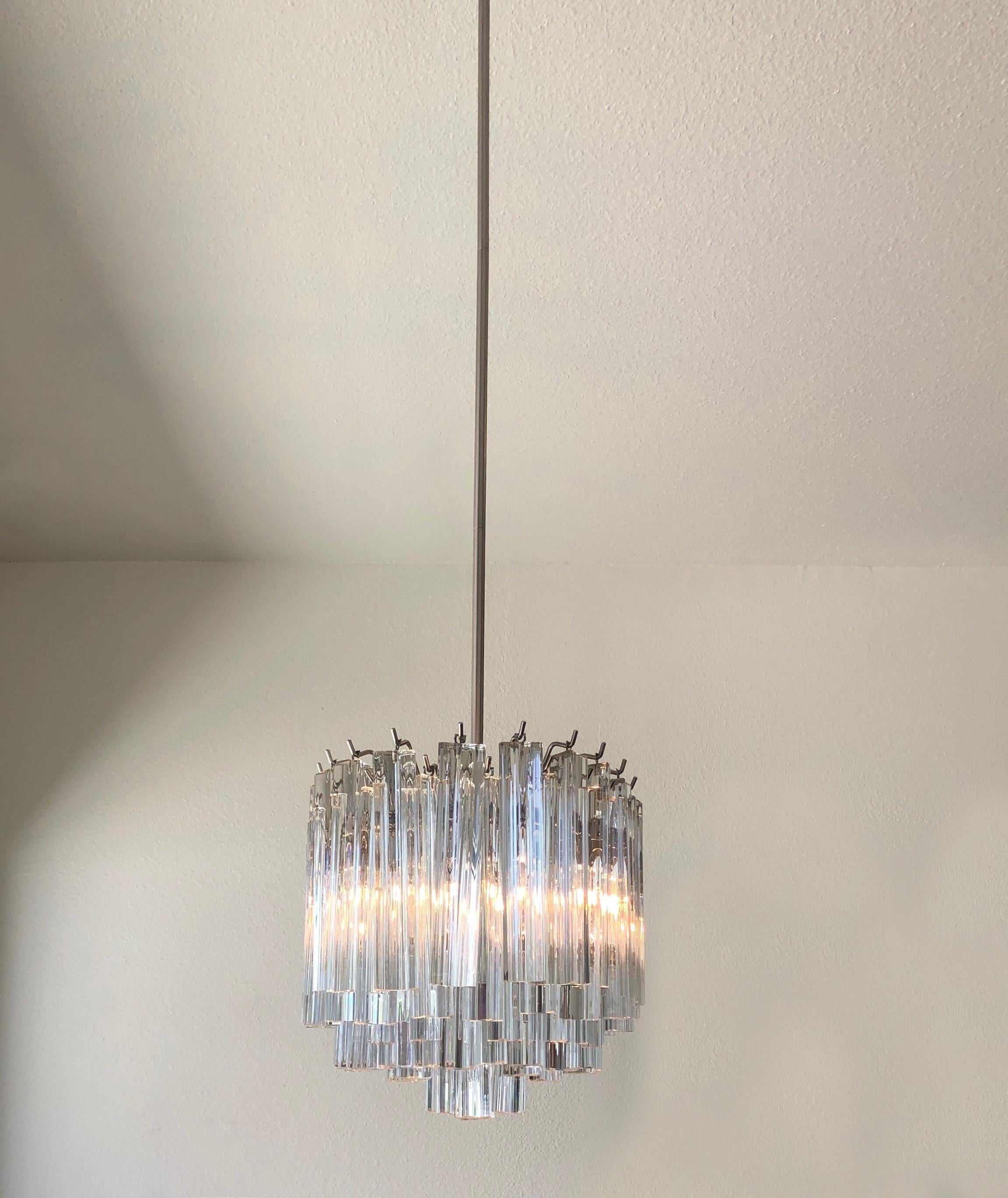 A glamorous 1970s clear Murano glass and stainless steel oval chandelier by Venini.
The chandelier has been newly rewired, It takes six candelabra lightbulbs. Overall height with rod is 50 inches, it can be shortened if desired.
Dimensions: 13”