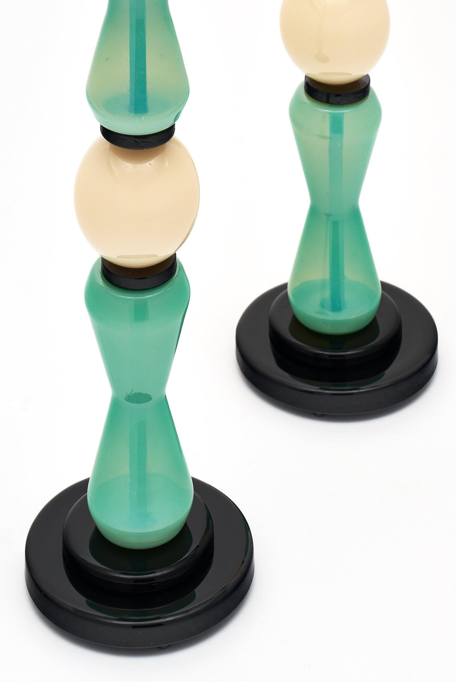 Unique pair of aqua and white Murano lamps. The hand blown vintage glass pieces are supported by a black glass base. These lamps have been newly wired to fit US standards.