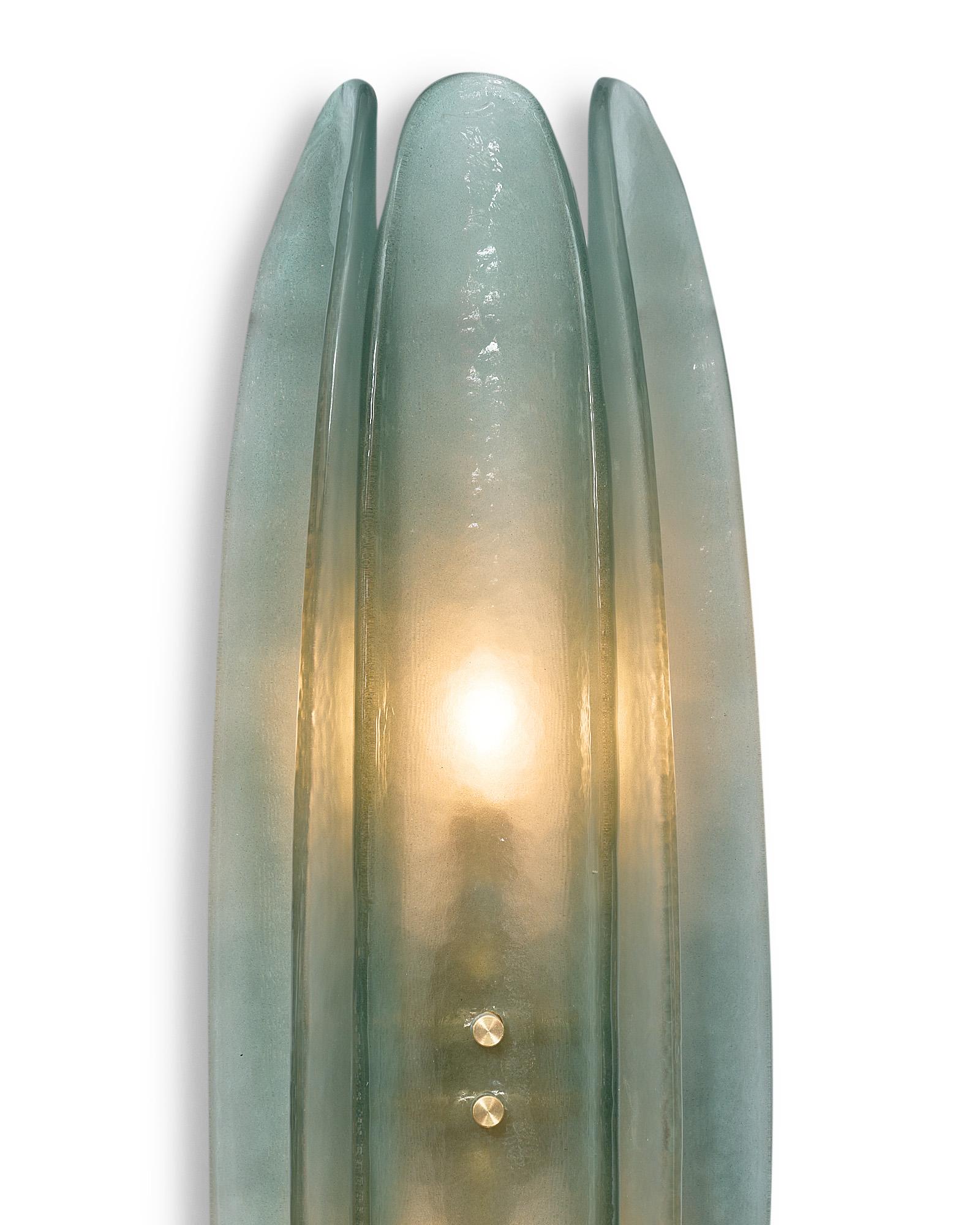 Pair of Murano glass paneled sconces, each crafted with three curved panels of hand-blown aqua glass on a brass frame. We love the modern style and hand-crafted quality of these sconces. They have been newly wired to fit US standards.
