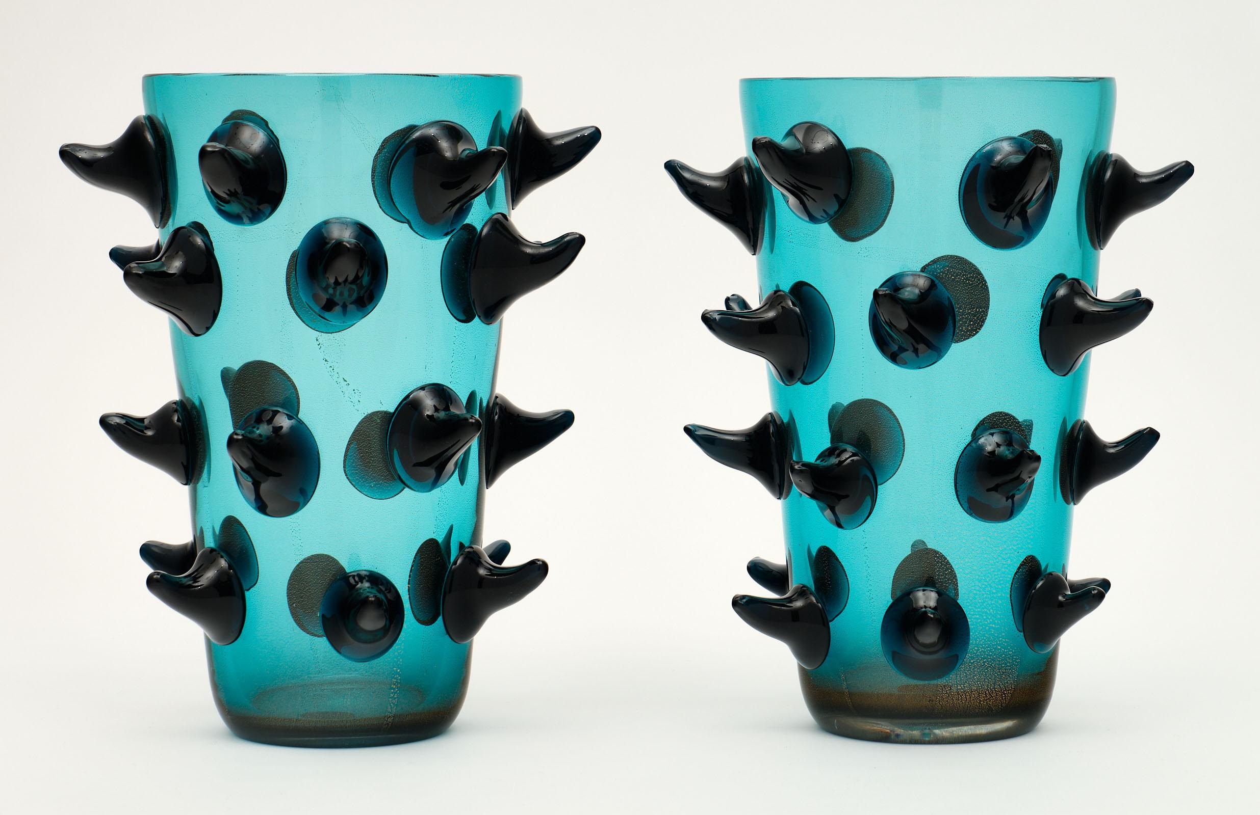 Pair of aqua Murano glass vases by Costantini featuring multiple spikes and an avventurina gold technique to add depth to the glass. We love the hand blown quality and blue-green color of this pair. They are signed.