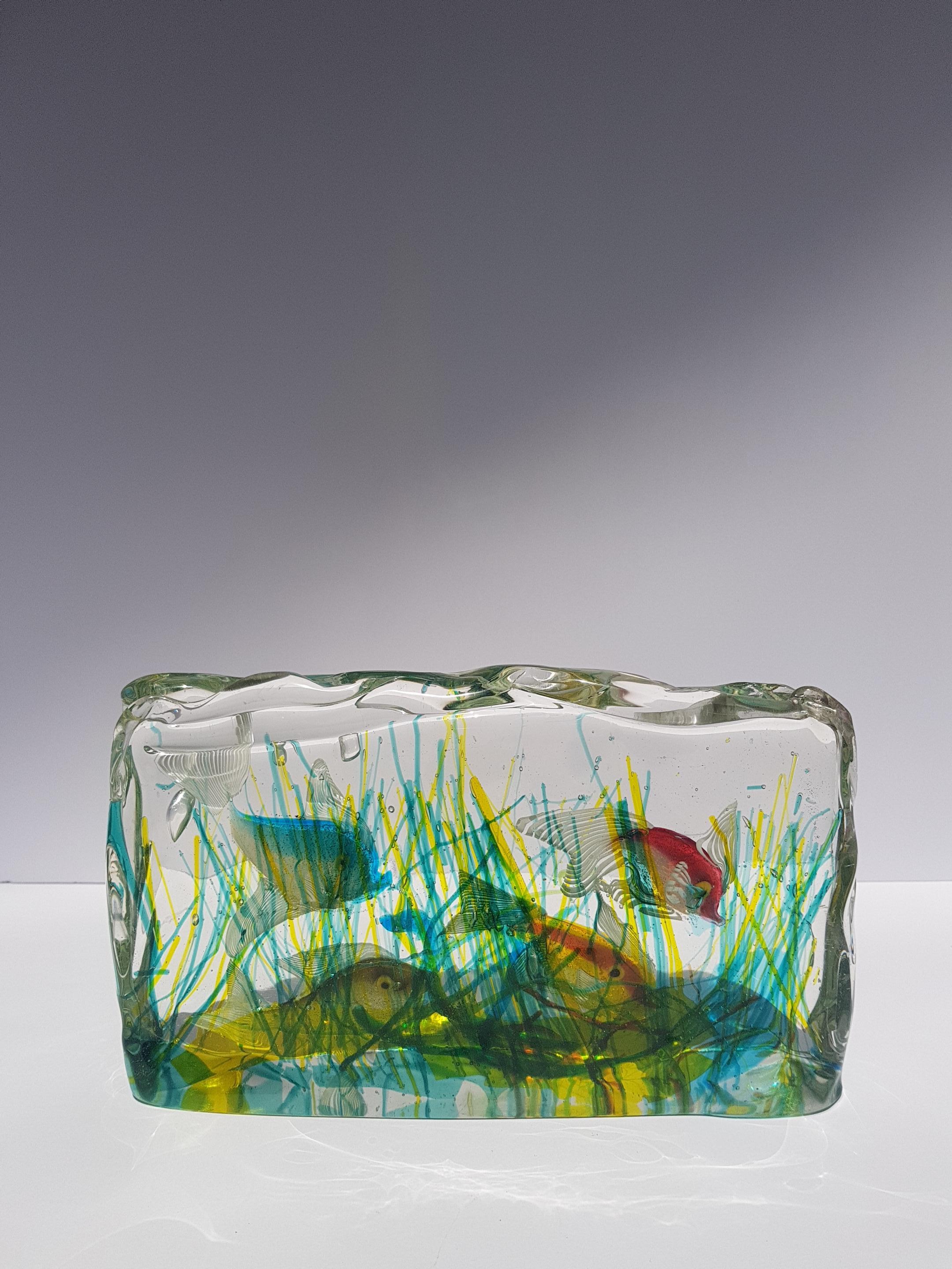 Rare genuine large murano glass aquarium sculpture by renowned murano glass artist Alfredo Barbini for Cenedese circa 1950. featuring four colorful fish swimming through multicolored reeds of sea plants or seaweed. Alfredo Barbini accomplished a