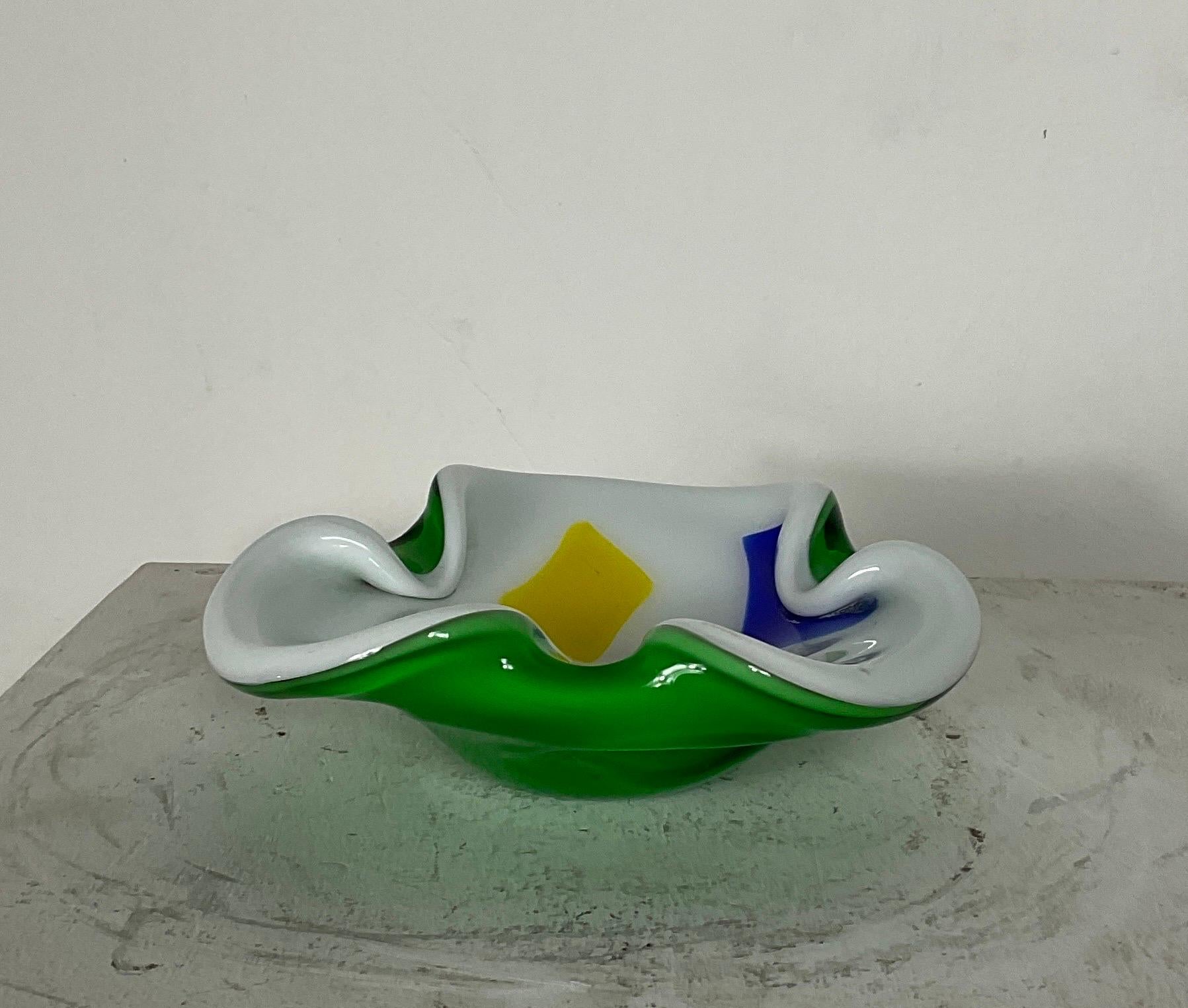 Murano glass ashtray attributable to Archimedes Seguso from the 60s with geometric figures coloured on white. The ashtray measures H 5cm D 16cm. Archimede Seguso was born in Murano on December 17, 1909.

At the age of 11 he began working in the