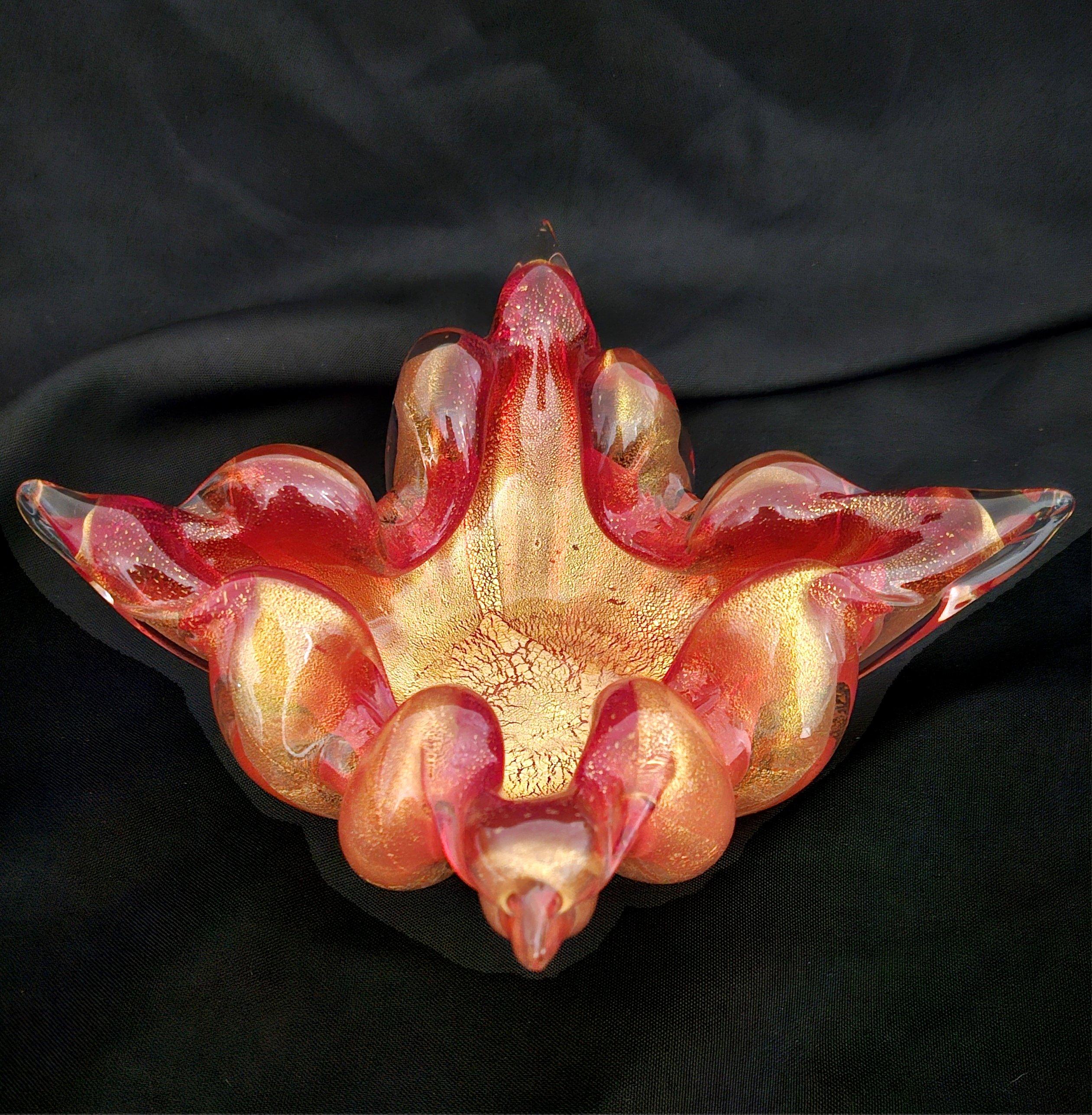 Murano Glass Ashtray, Red w/Gold Polveri / Gold Leaf, Barovier & Toso (assumed)
No chips or cracks. Excellent vintage condition. A rare beauty!
Measures about 8 (point to point) x 5 (side to side) x 3 (height) inches.


Measurements are approximate