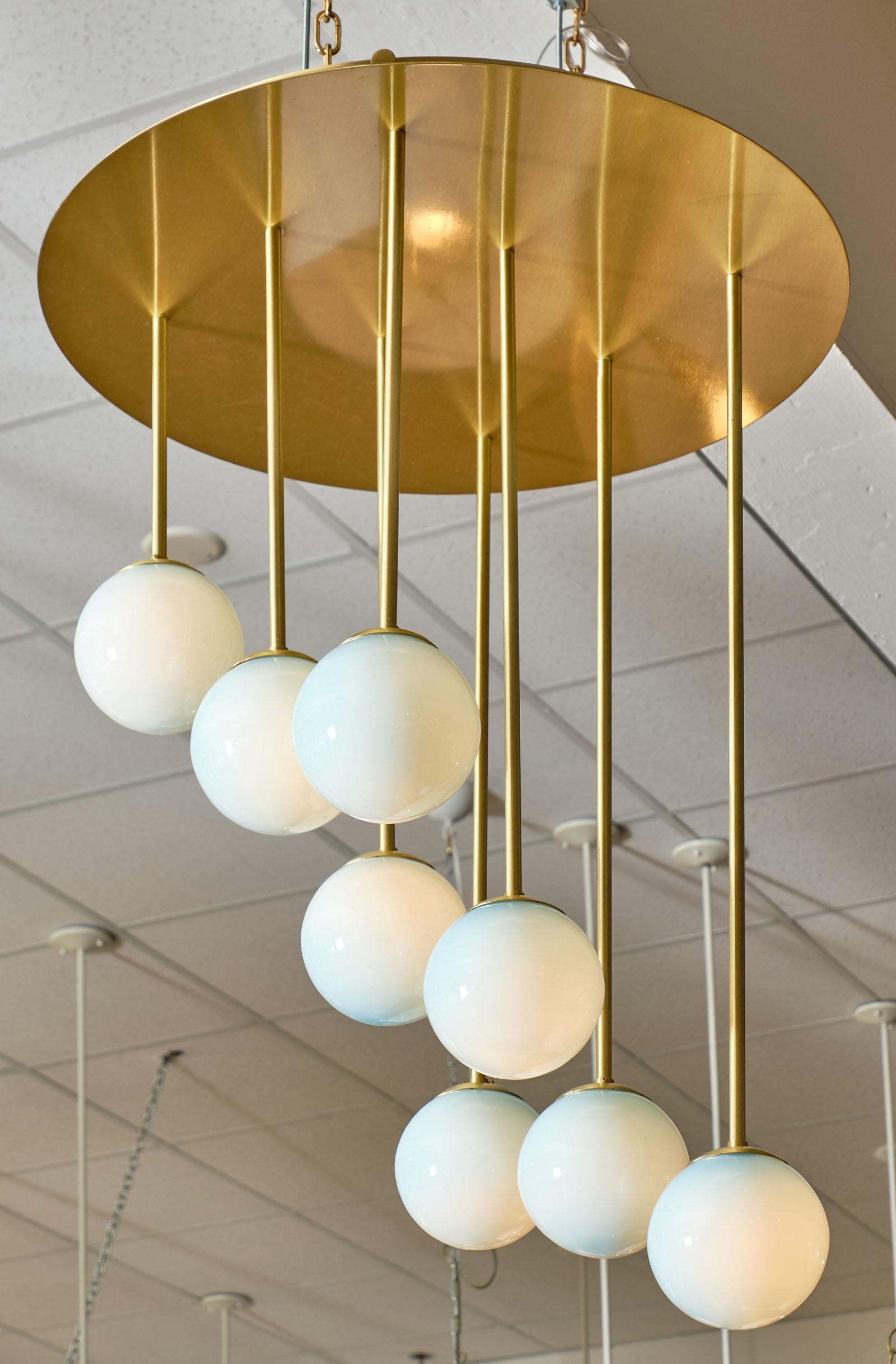 Murano glass “atoms” chandelier featuring a brushed brass structure and eight hand blown “atom” spheres in a light blue opaque color. We love this unique flush mount fixture. It has been newly wired to fit US standards.

This piece is currently