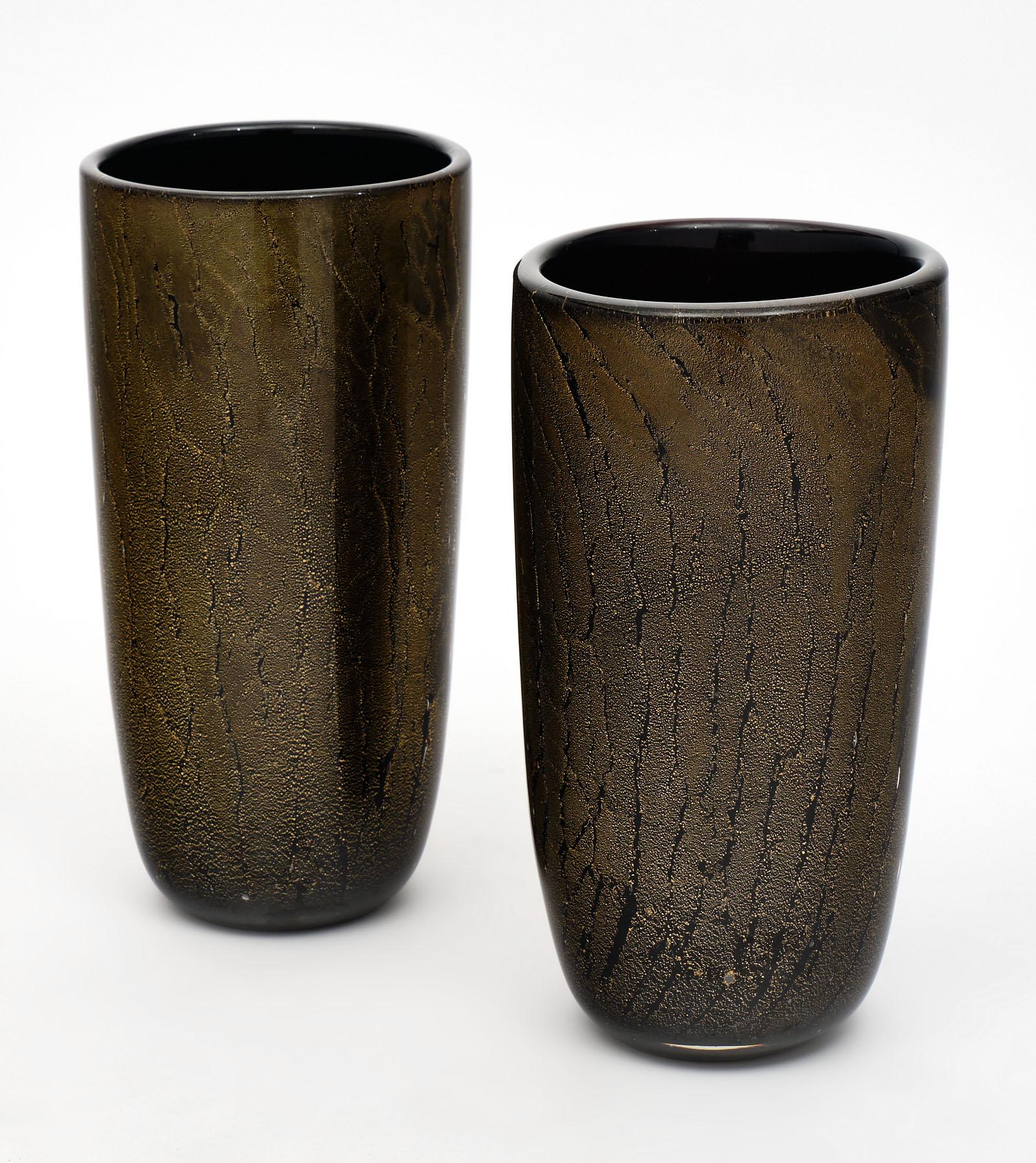 Black and Avventurina Murano glass vases with 23-carat gold leaf applied to the black glass while still in fusion. We love these hand blown pieces, which exude superb craftsmanship. As these vases are hand blown by craftsman in Italy, the size and