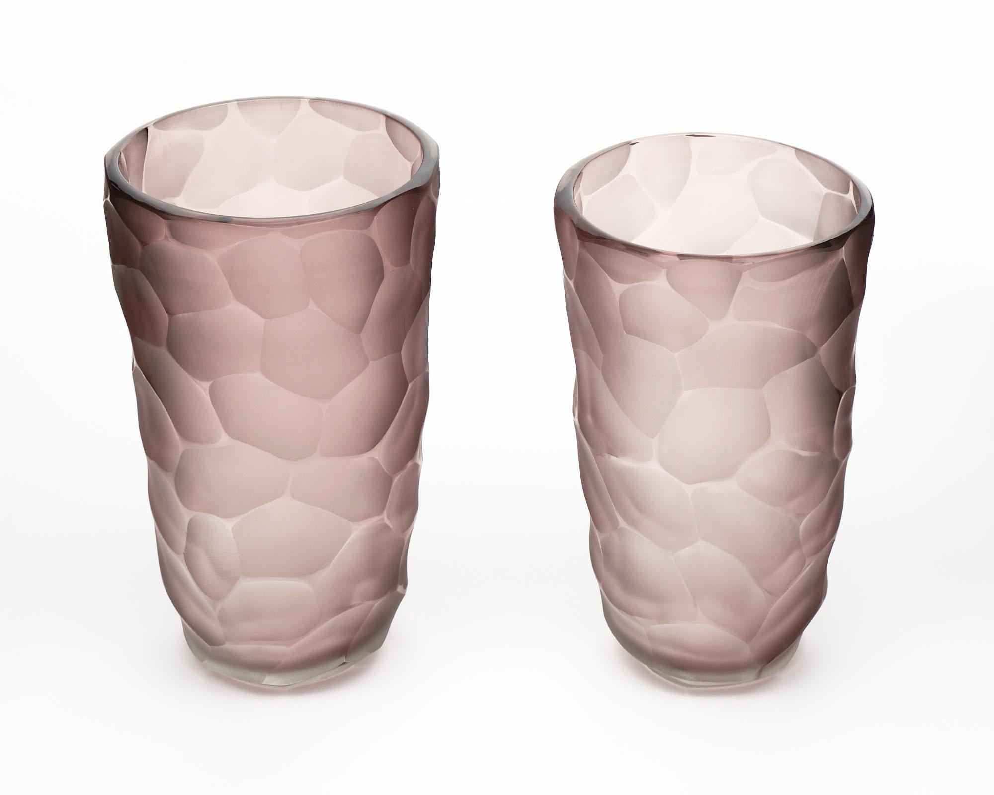 A pair of vases, amethyst color, from the Island of Murano, in the Manner of Carlo Scarpa. The measurements listed are for the larger vase, the measurements for the smaller vase are listed below. 

Diameter: 9.62”

Height: 15.25”.