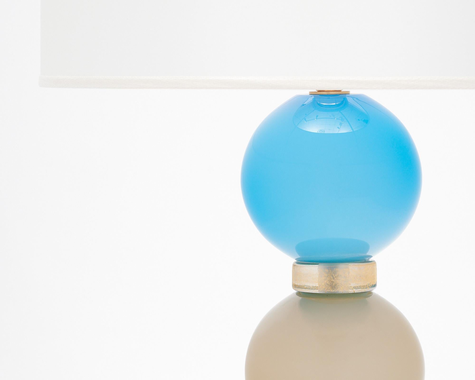 Murano glass table lamps from the island of Murano outside of Venice, Italy. This hand-blown pair alternates striking bright blue colored spheres with gray colored ones. They have been newly wired to fit US standards.

