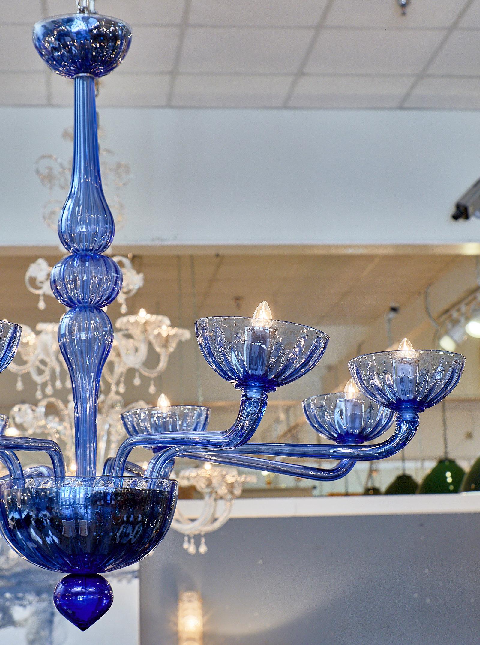 Blue Murano glass chandelier featuring ten branches, large bobeches, and a blown glass stem.