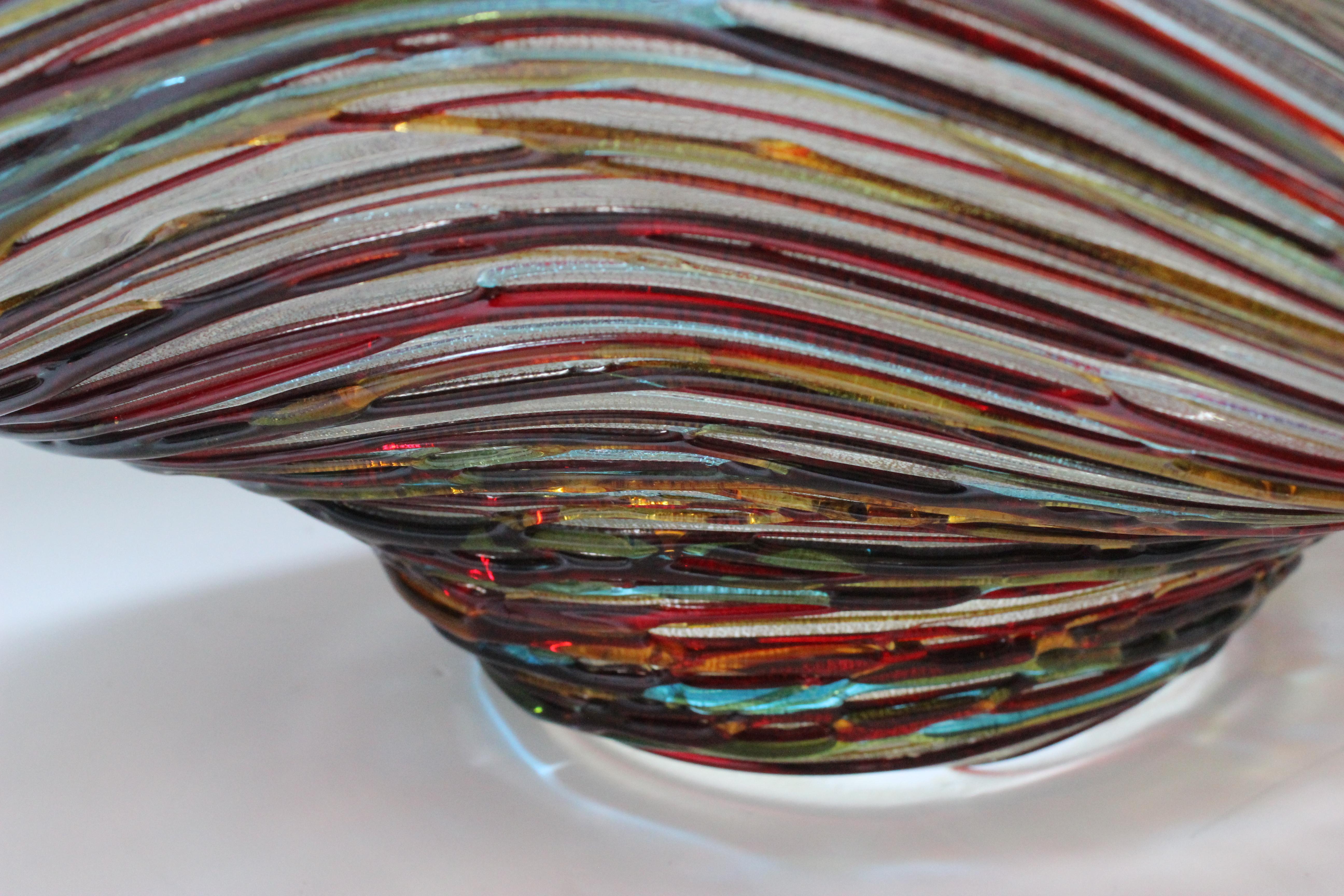 This stylish and chic Murano glass bowl dates to the 1990s and was created by Vetro Artistico. The interior is smooth and the outside is detailed with striaed, multi-colored glass rods. 

Note: Signed on the verso by the glass artisan (see images).