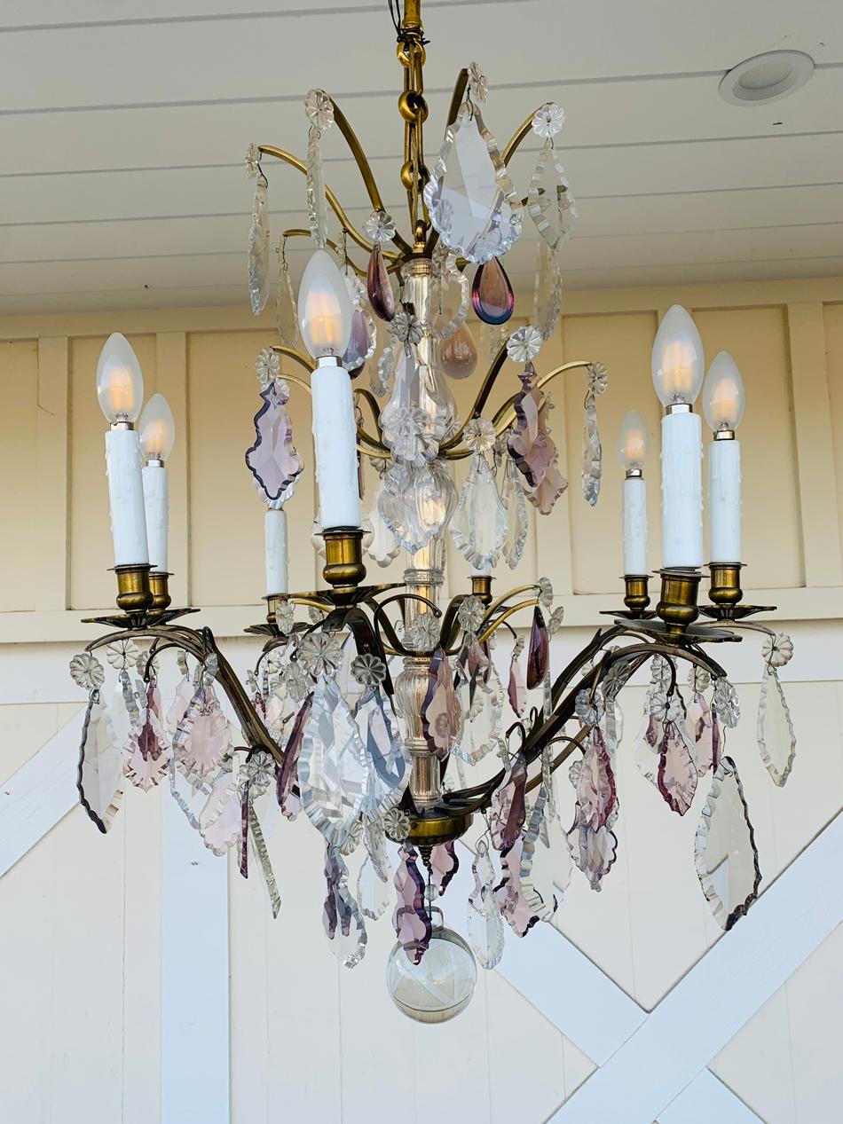 Beautiful murano glass and brass chandelier with 8 arms and candle like lights.

The chandelier is beautiful, delicate yet very imposing, hard wired and fully functional.
Measurements:
43 inches high from bottom to canopy x 23.50 inches in diameter.