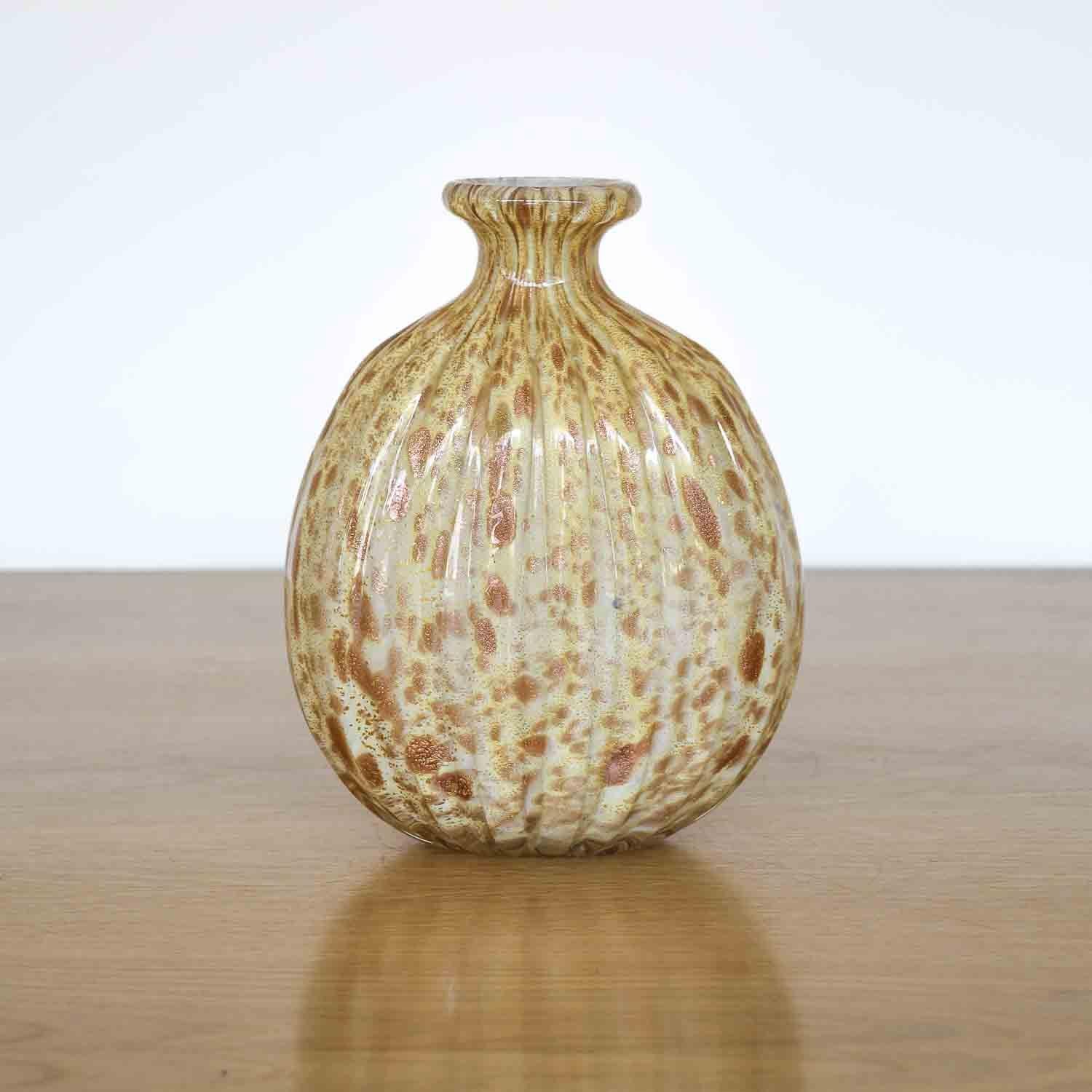 Beautiful vintage Italian vase made of gold-colored Murano glass. Ribbed blown glass with gold and bronze flecks. Stunning and unique piece.