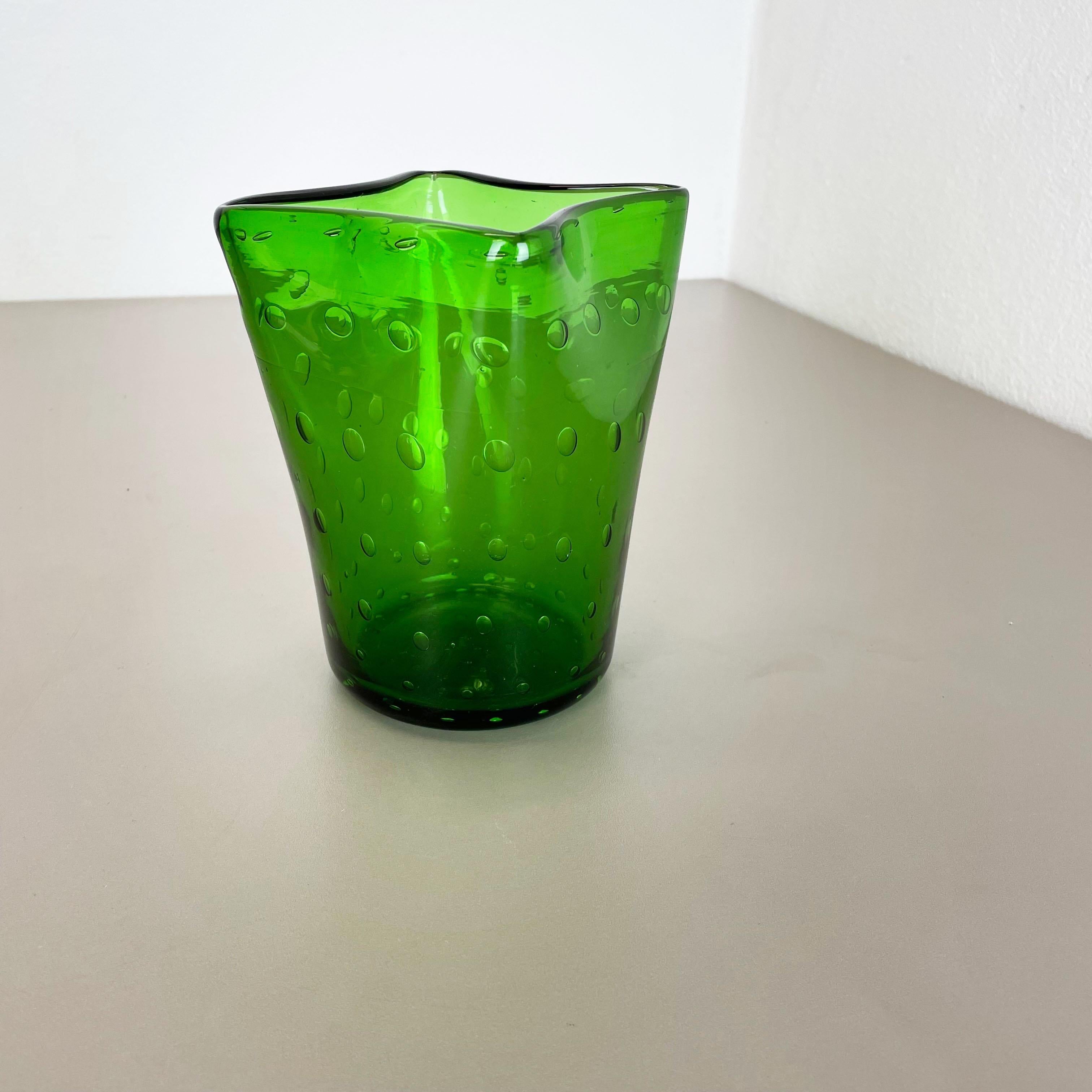 Article:

Murano glass vase element


Origin:

Murano, Italy


Decade:

1970s


This original glass vase element was produced in the 1970s in Murano, Italy. An elegant green Murano glass element utilizing the bullicante technique of controlled