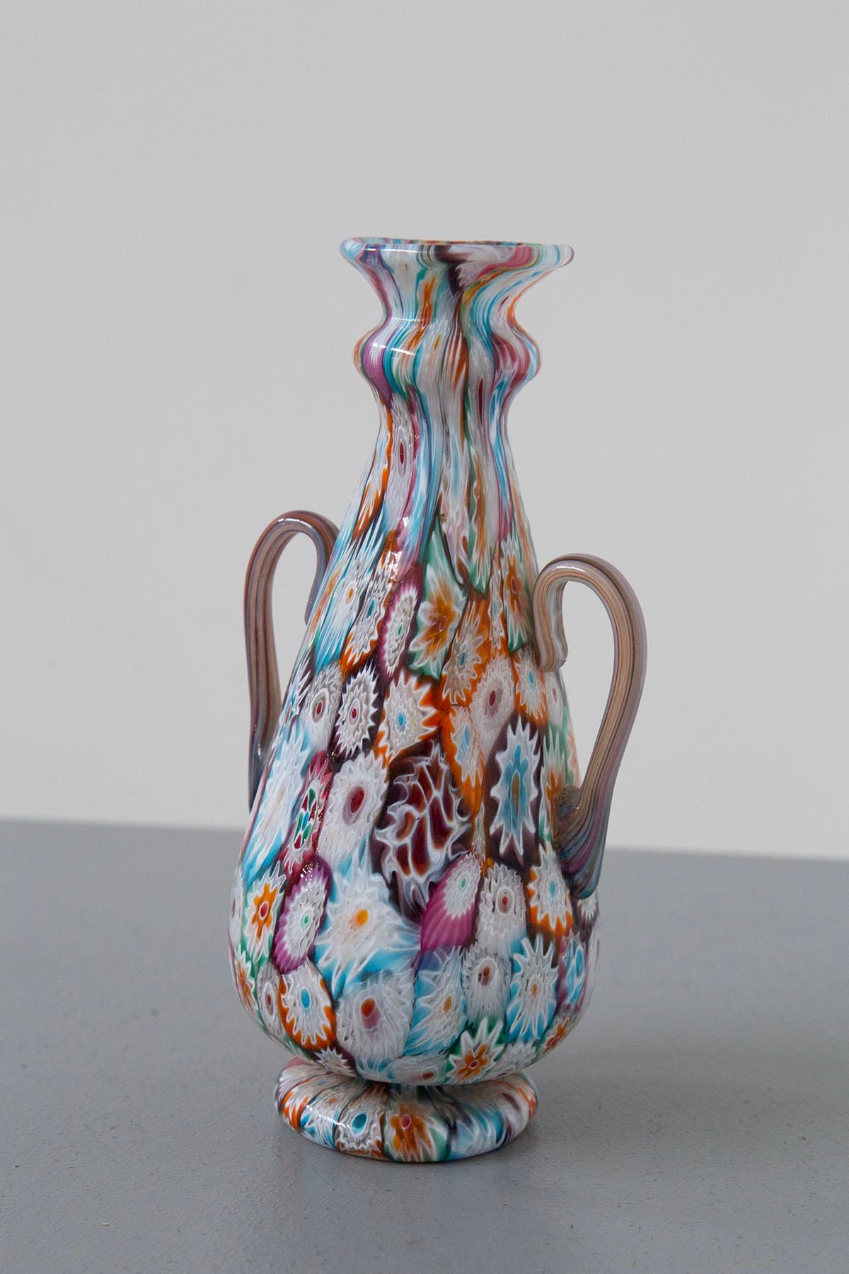 Behold the exquisite grandeur of a decorative vase, a true masterpiece, born from the artistic glassblowing tradition of Murano. This magnificent creation is adorned with a handcrafted mosaic of a thousand flowers, known as 