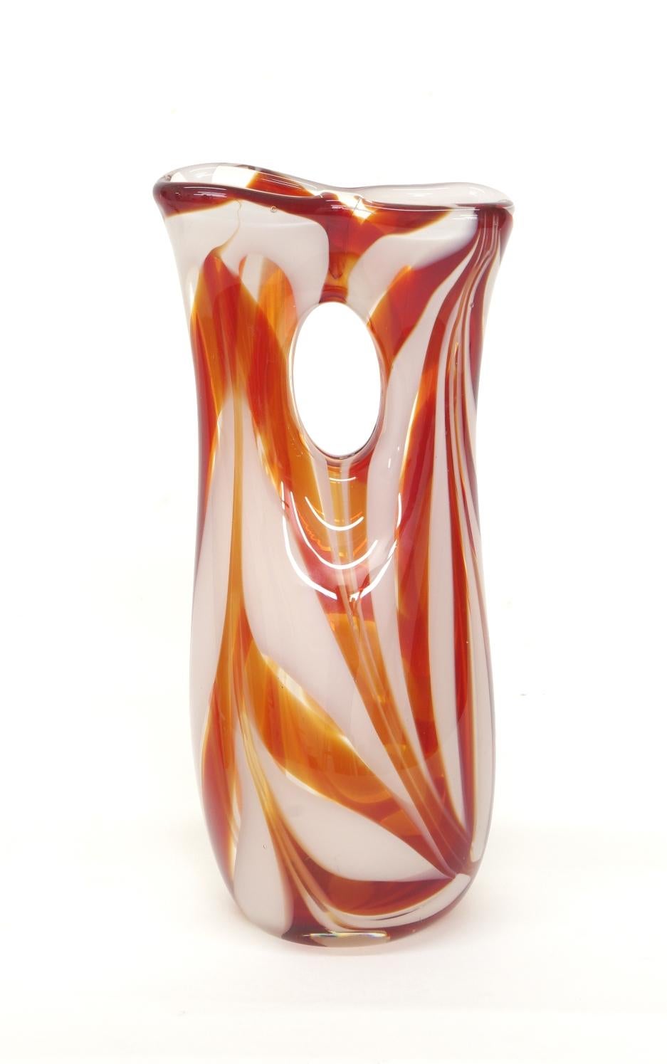 Murano glass vase, orange/red and white candy stripe glass in a clear matrix. Unsigned, with a polished pontil.

This cheerful vase draws its inspiration from ancient glass cosmetic tubes or 'kohl tubes'. Kohl was a black makeup used as eyeliner