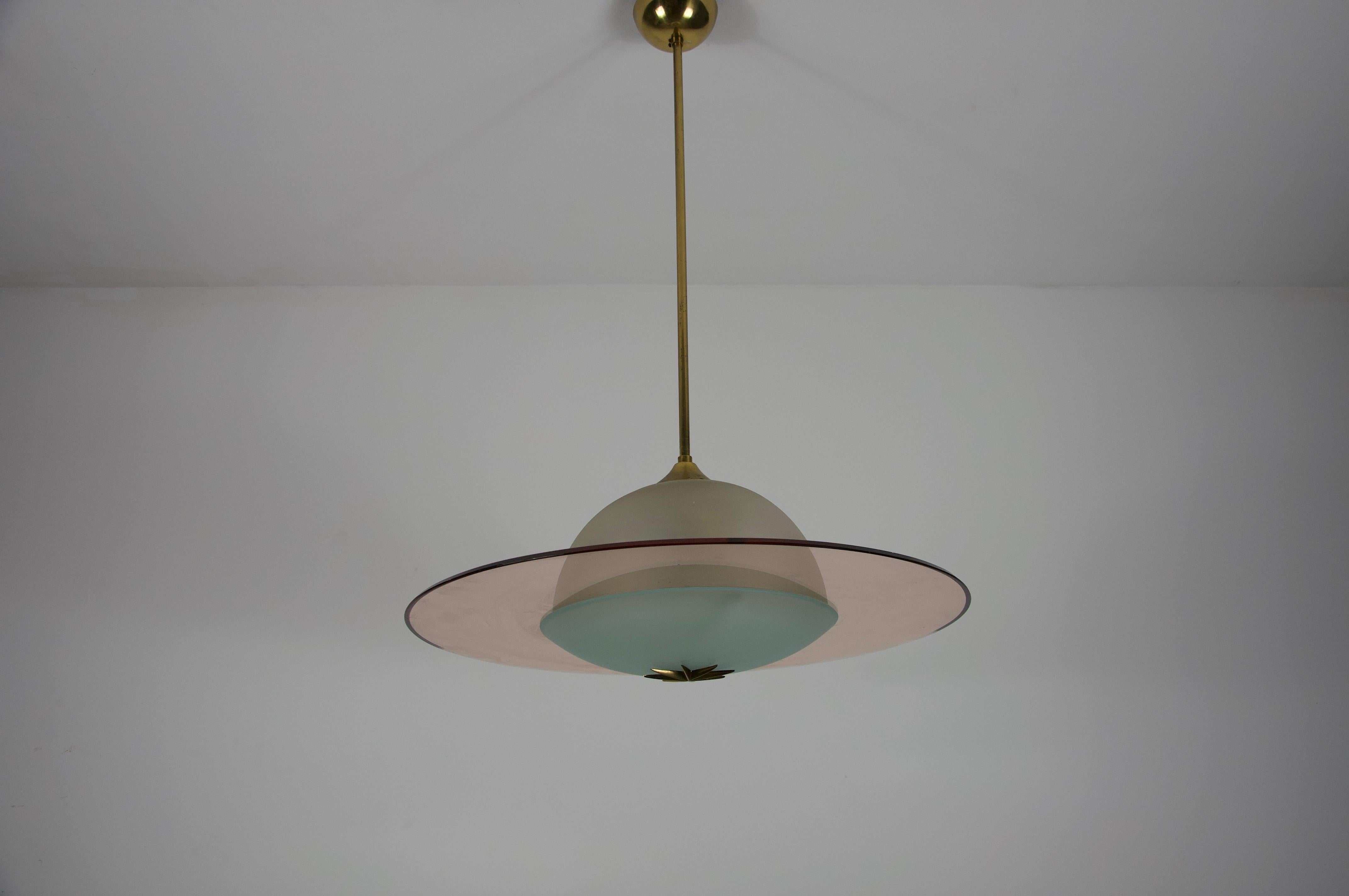 Esta exquisita araña de cristal de Murano encarna la refinada estética del diseño italiano de mediados de siglo, circa 1950. Atribuida al influyente diseñador Pietro Chiesa para Fontana Arte, esta pieza es un testimonio de la sofisticada iluminación