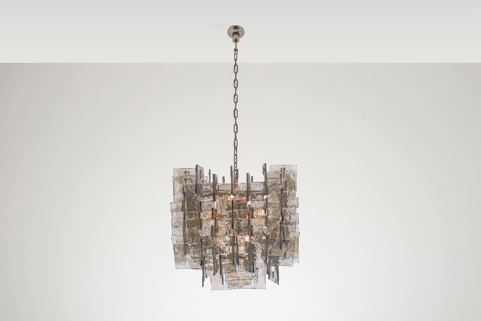 Impressive Murano glass chandelier by Carlo Nason for Mazzega, Italy 1970s. The chandelier contains 128 handmade Artistic glass pieces with a nice structure, including 2 spare ones. The C-shaped glass pieces hangs on a white lacquered square frame,