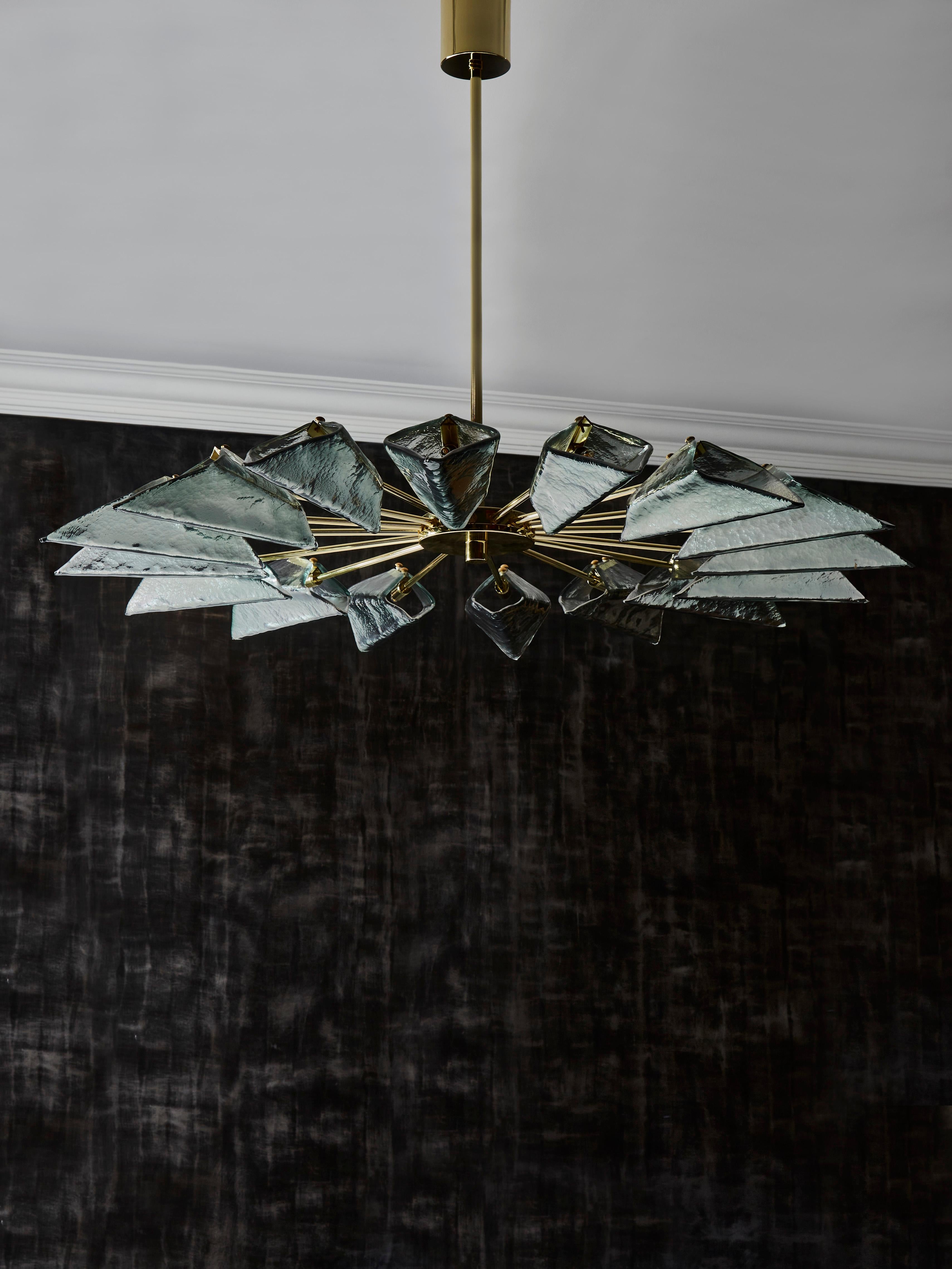 Brass and Murano glass chandelier.
Creation by Studio Glustin.

G9 light bulbs.