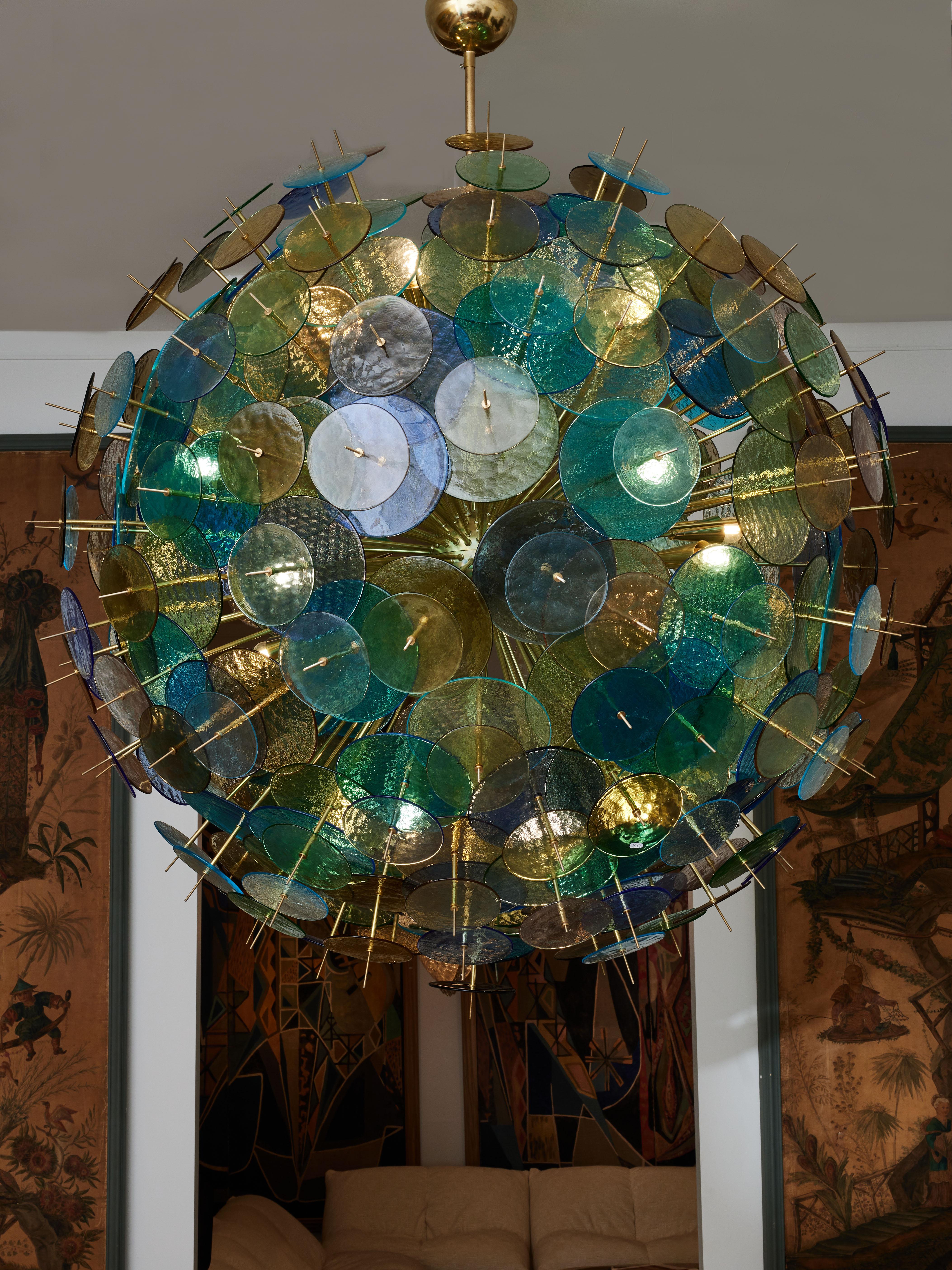 Sputnik chandelier in brass with tainted Murano glass plates.
Creation by Studio Glustin.