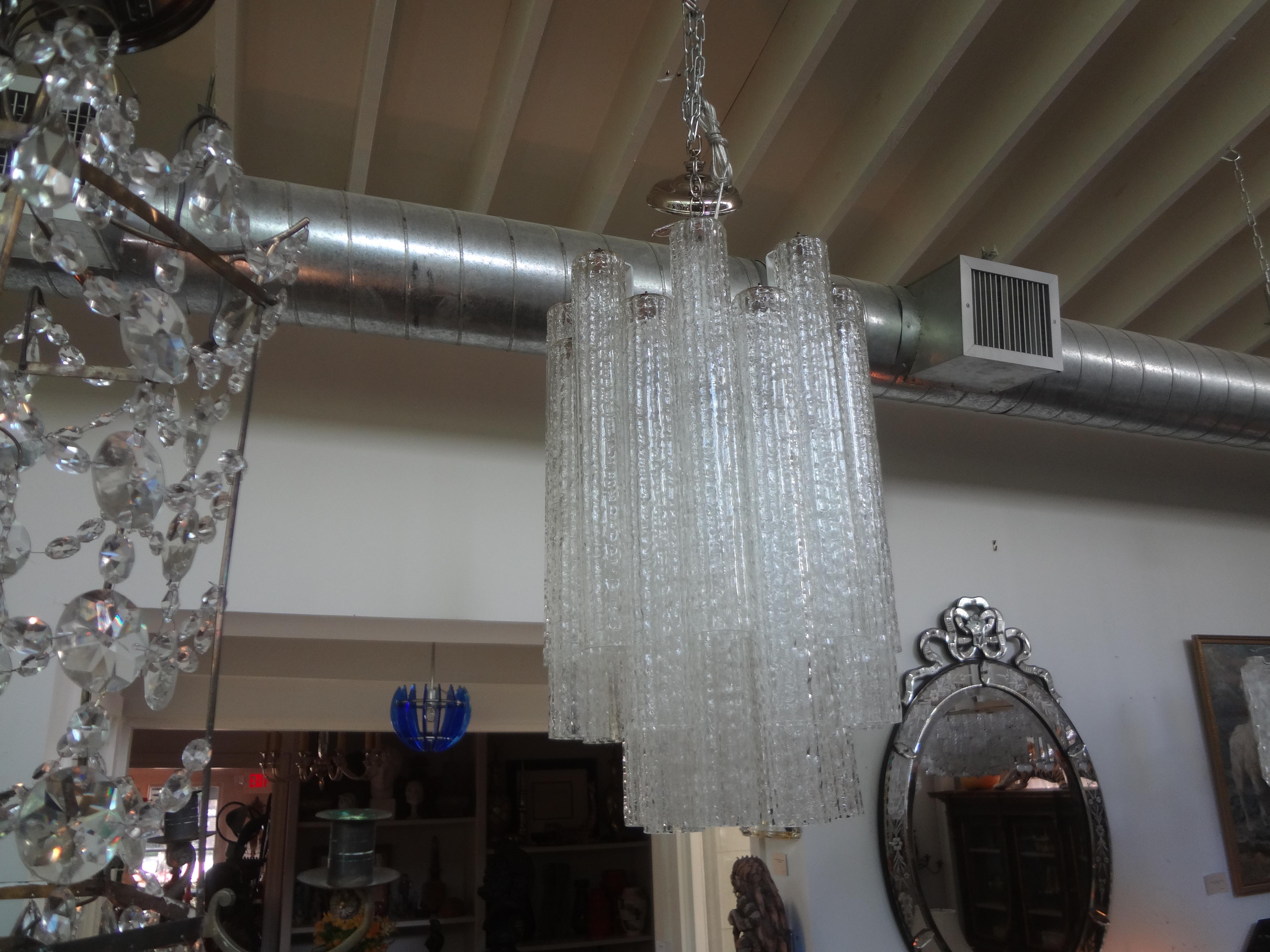 Murano glass chandelier by Toni Zuccheri For Venini.
Our unusual vintage Italian chandelier, pendant or lantern is comprised of 18 inch hand blown Murano glass tubes suspended from a chrome frame. This lovely Venini lantern has been newly wired