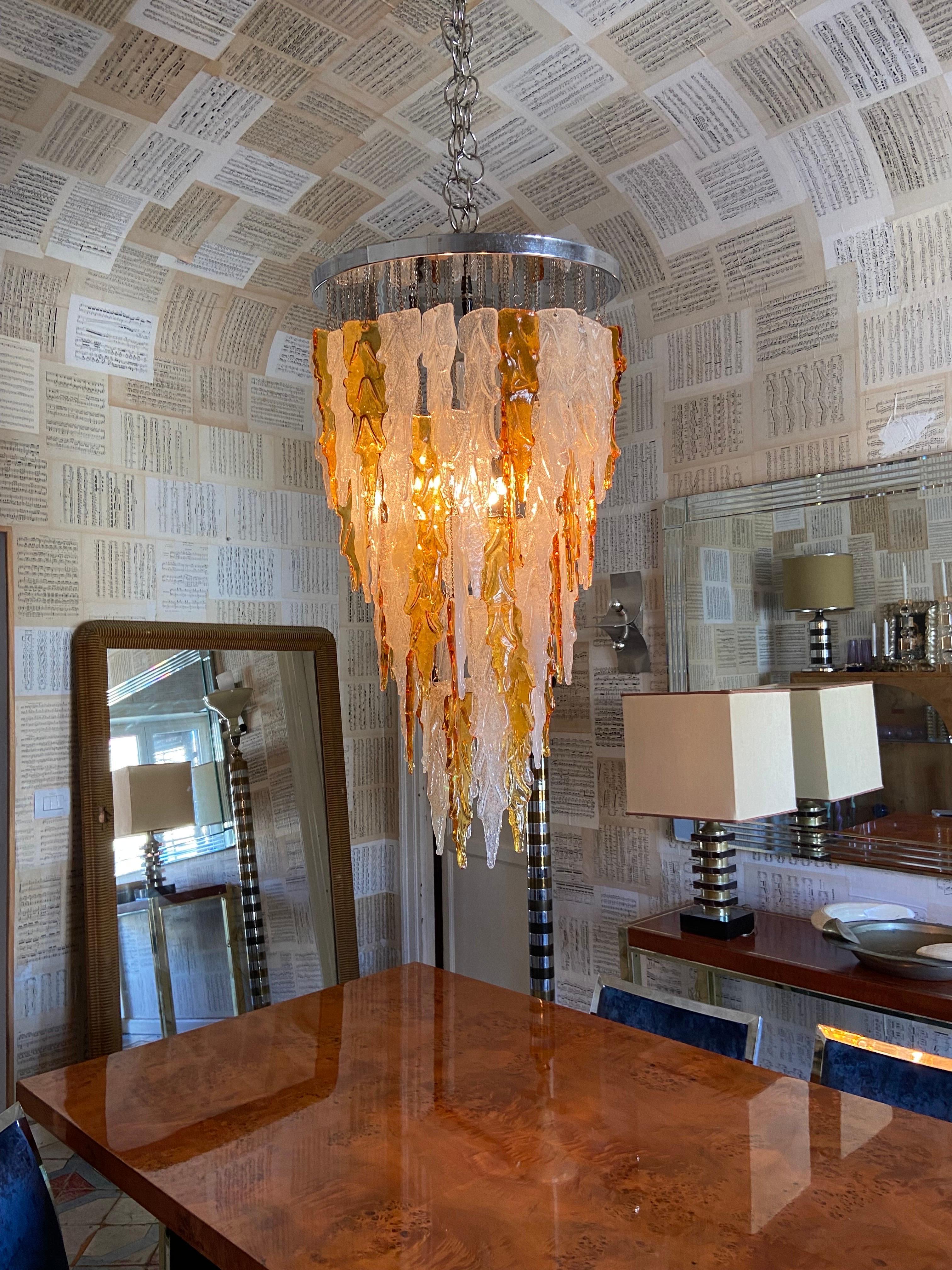 Amazing chandelier designed by Albano Poli. Suspension lamp, cylinder body, chromed metal structure decorated with white and amber Murano glass leaves. Poliarte production, Italy 1970 ca.

Details
Creator: Albano Poli, Murano
Dimensions: Height: