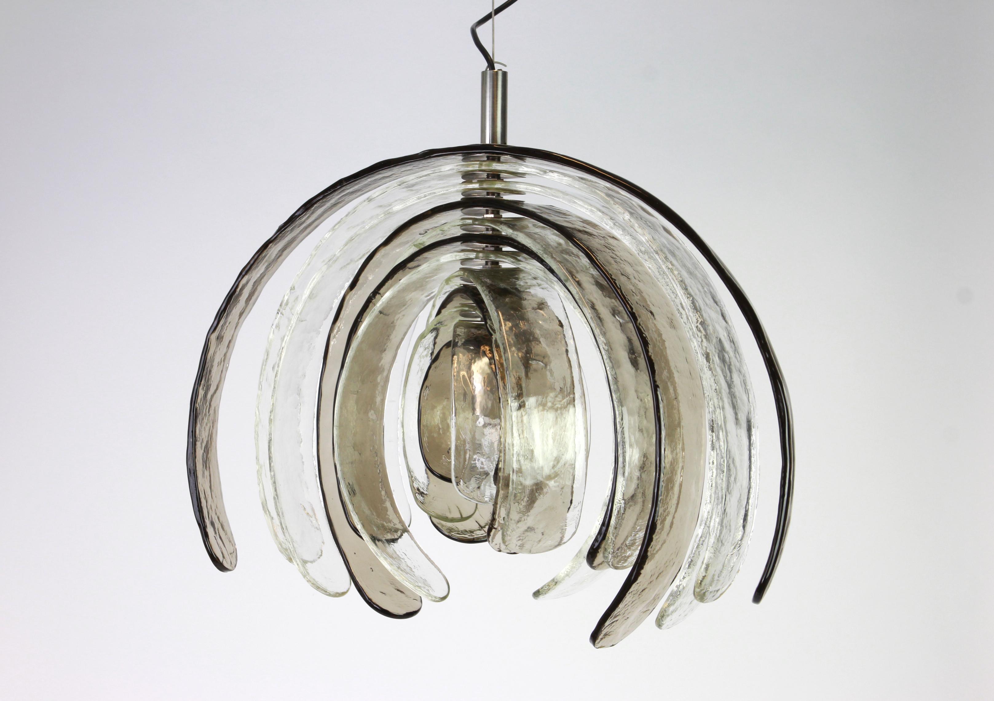 A stunning huge Murano glass chandelier designed by Carlo Nason for Kalmar, Austria, manufactured in the 1960s.
The chandelier is composed of 12 thick Murano glass elements attached to a chrome metal frame.

High quality and in very good