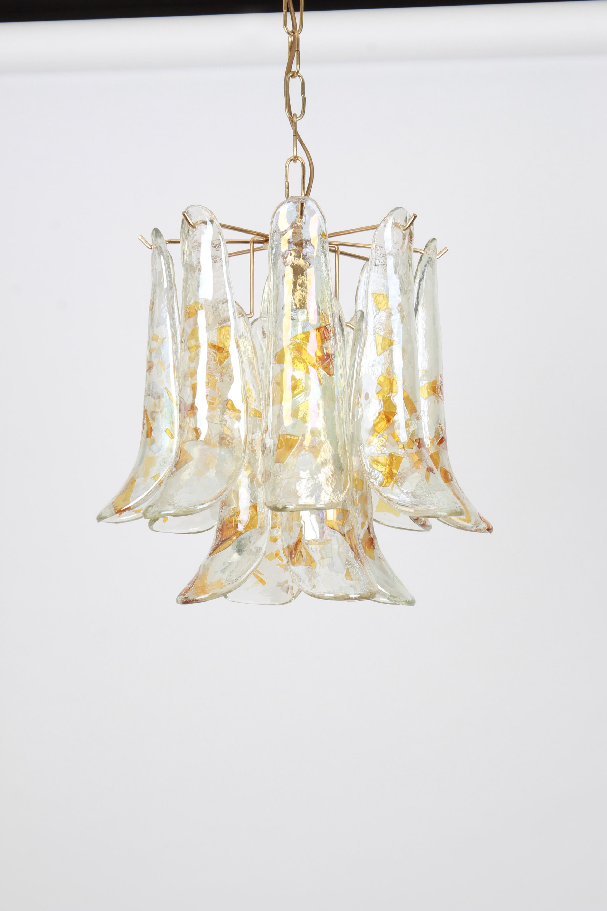 A stunning Murano glass chandelier designed by Carlo Nason for Mazzega, Italy, manufactured in the 1970s.
The chandelier is composed of 12 thick textured glass elements attached to a brass metal frame.

High quality, very good condition. Cleaned,