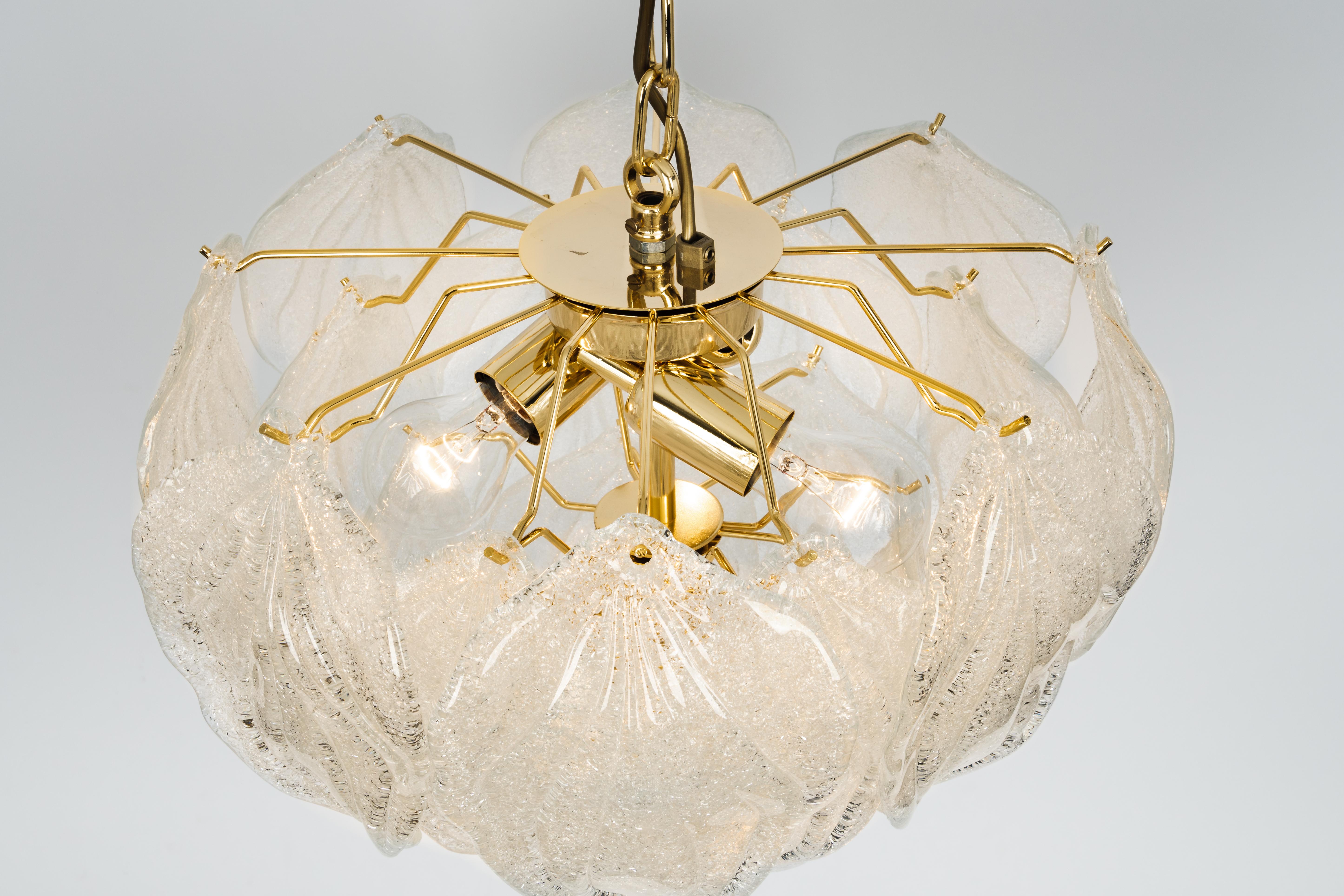 A stunning Murano glass chandelier designed by Carlo Nason for Mazzega, Italy, manufactured in the 1970s.
The chandelier is composed of 19 thick textured glass elements attached to a brass metal frame.

High quality, very good condition. Cleaned,