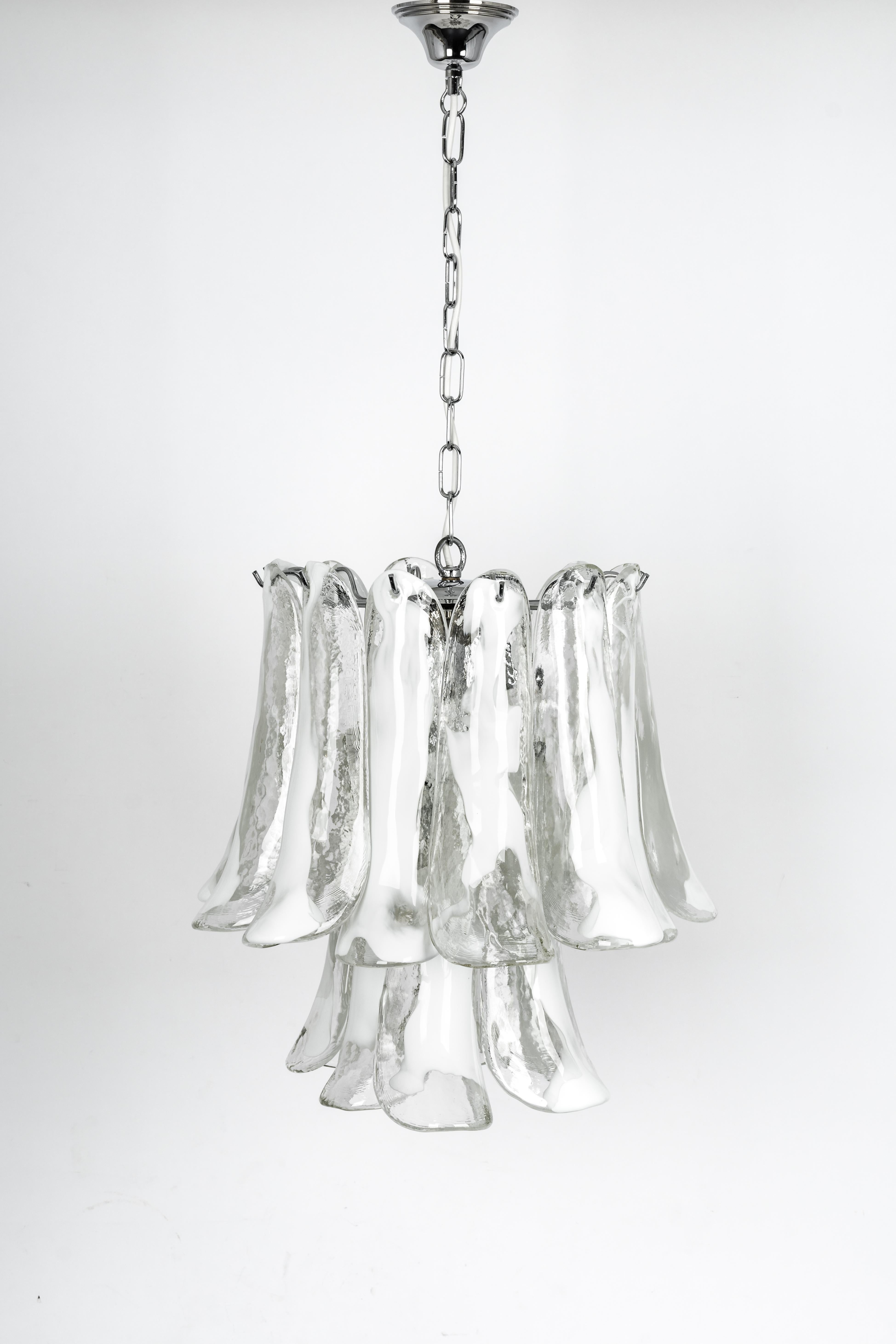 A stunning Murano glass chandelier designed by Carlo Nason for Mazzega, Italy, manufactured in the 1970s.
The chandelier is composed of 19 thick textured glass elements attached to a chrome metal frame.

High quality, very good condition.