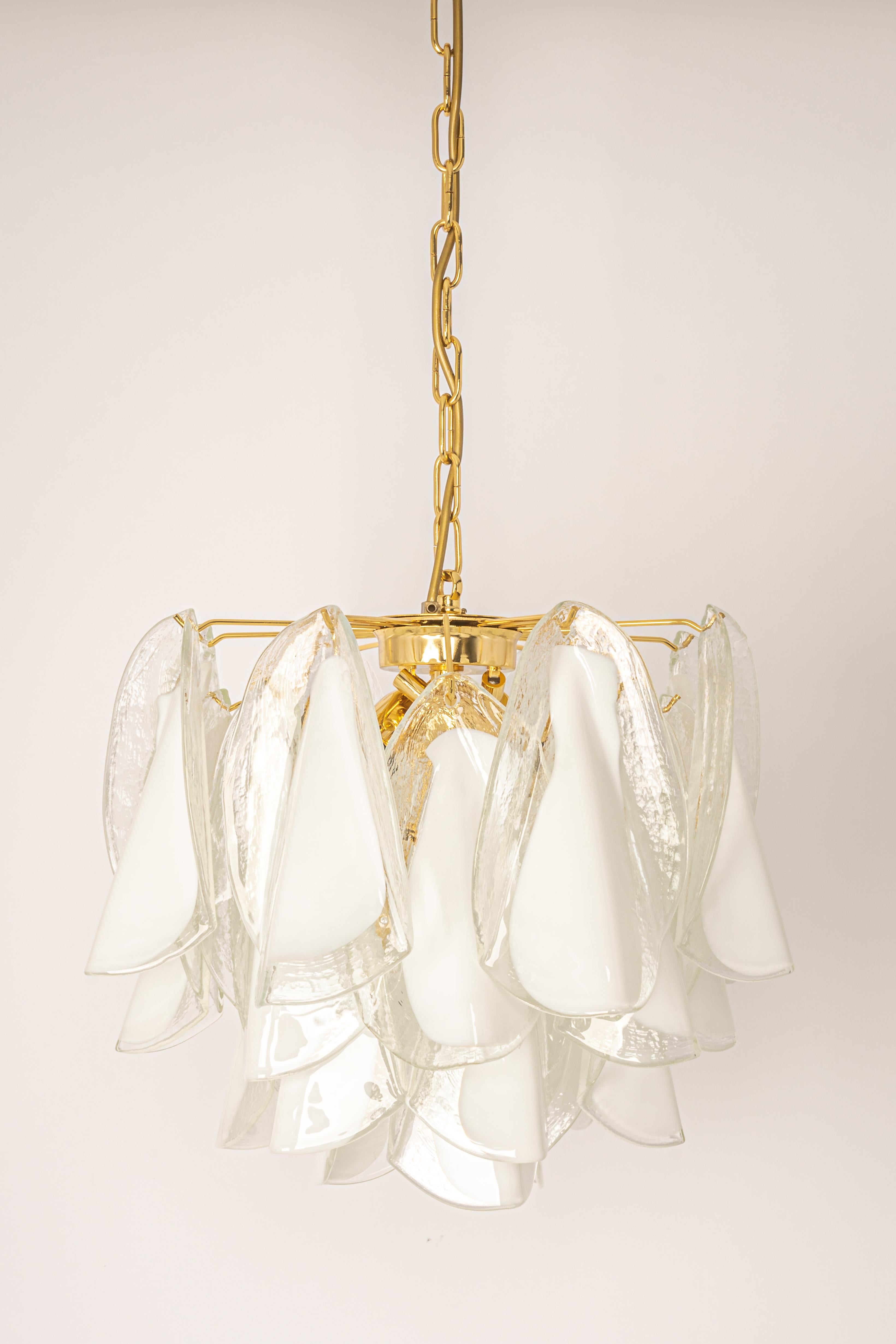 A stunning Murano glass chandelier designed by Carlo Nason for Mazzega, Italy, manufactured in the 1970s.
The chandelier is composed of many thick textured glass elements attached to a gilt brass frame.

High quality, very good condition.