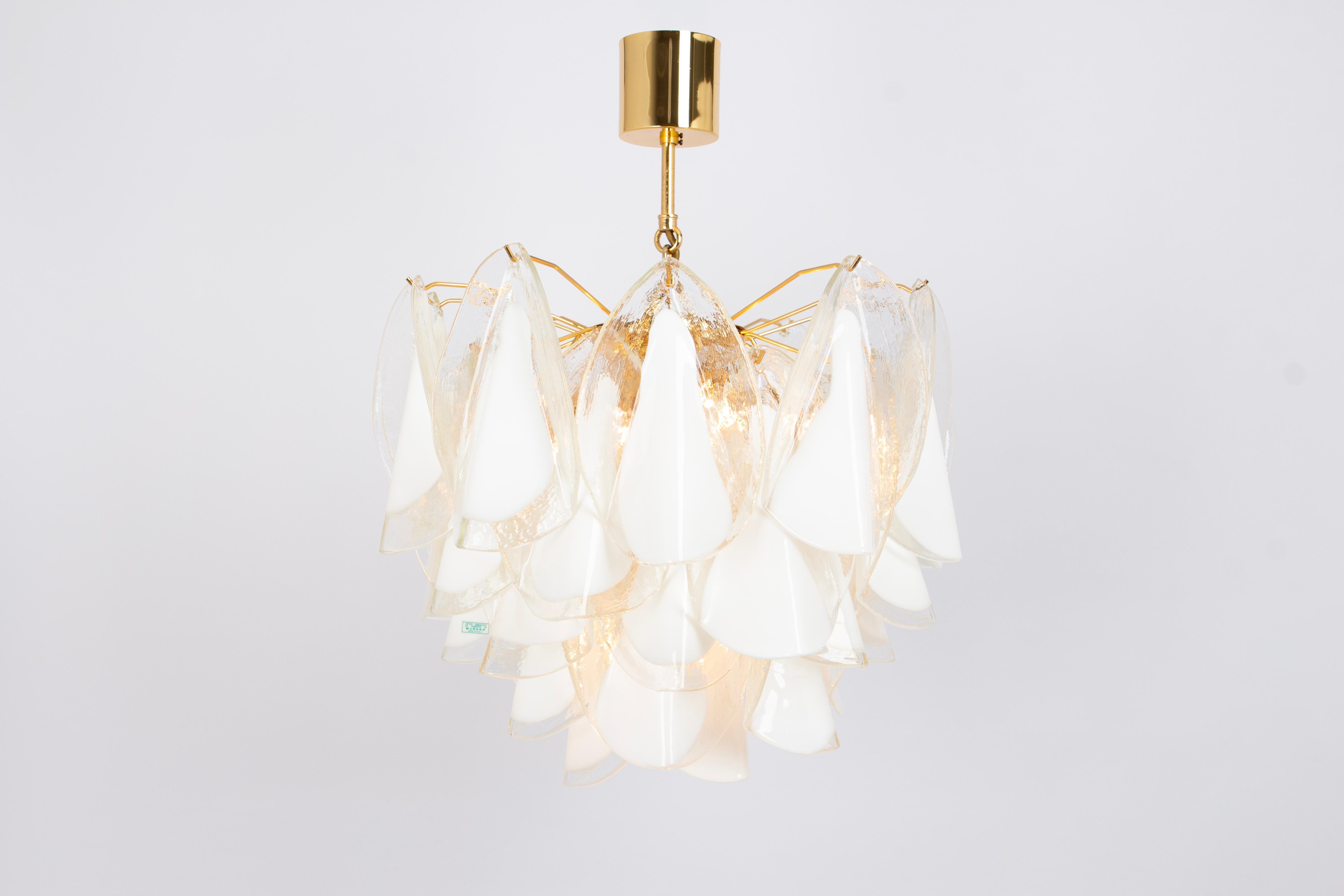 A stunning Murano glass chandelier designed by Carlo Nason for Mazzega, Italy, manufactured in the 1970s.
The chandelier is composed of many thick textured glass elements attached to a gilt brass frame.

High quality, very good condition. Cleaned,